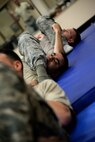 Senior Airman Abraham Mercado, 47th Security Forces Squadron combat arms instructor, submits to an ‘arm bar’ in Losano Fitness Center on Laughlin Air Force Base, Texas, July 10, 2015. The United States Air Force has at times in its history been at the forefront of combatives training. In 1951 General Curtis Lemay appointed Emilio "Mel" Bruno, his Judo teacher and a former national American Athletic Union Wrestling champion and fifth degree black belt in Judo, to direct a command wide Judo and combative measures program. (U.S. Air Force photo by 2d Lt. Taylor S. Peterson)(Released)