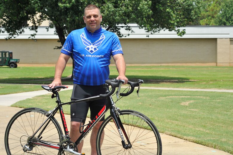 Alabama Air National Guard Tech. Sgt. Jody Hershbine prepares to ride across the United States to raise money for the Wounded Warrior Project, July 1, 2015. Hershbine will ride over 3,500 miles from Savannah, Ga. to Astoria, Ore. (U.S. Air Force photo by Tech. Sgt. Matthew Garrett)