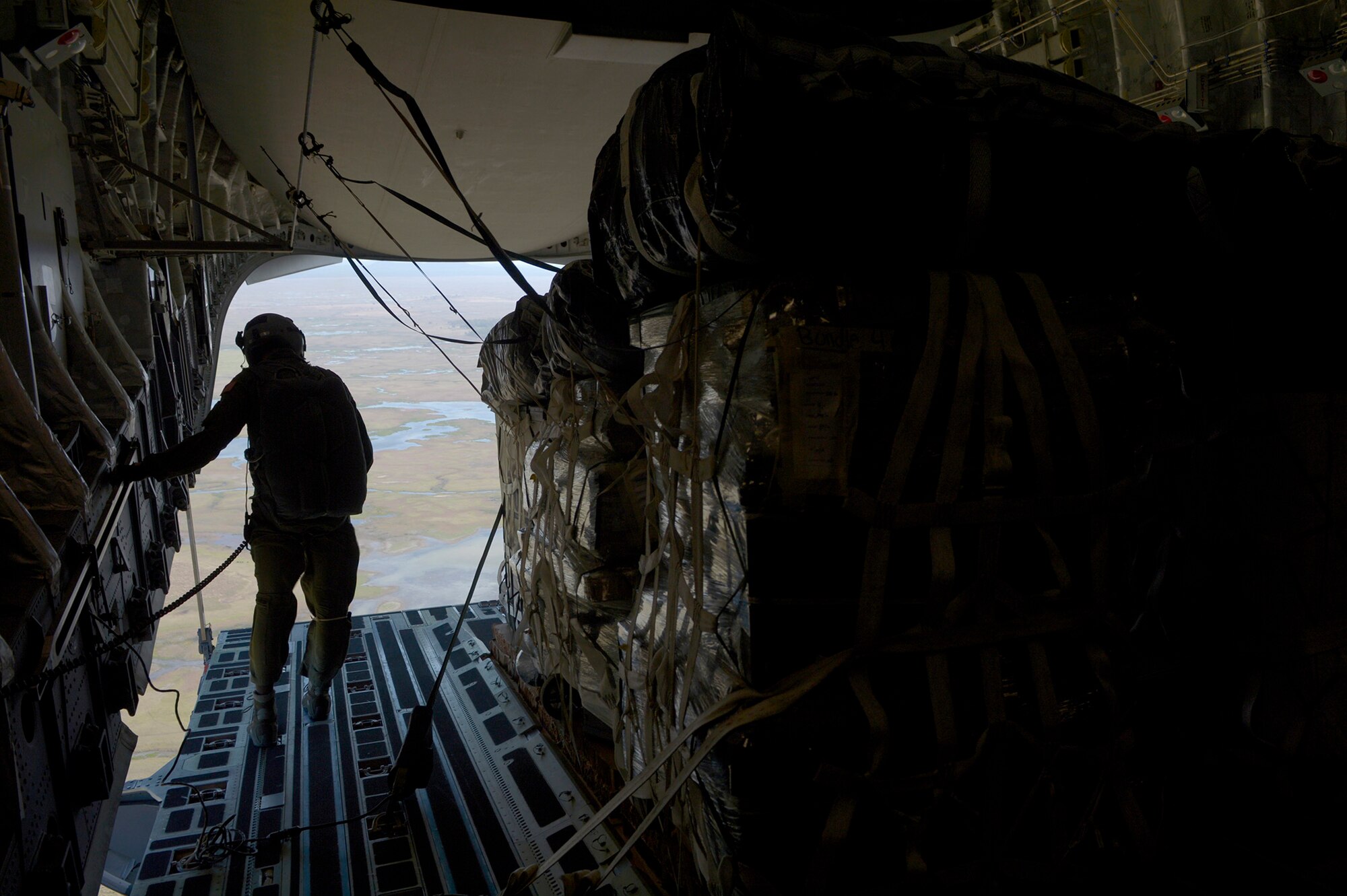 Senior Master Sgt. Ty Brooks, C-17 Globemaster III loadmaster from the 313th Airlift Squadron, inspects equipment prior to air dropping four container delivery systems over Kapyon drop zone, Australia, during Exercise Talisman Sabre July 8. Talisman Sabre 2015 is jointly sponsored by the U.S. Pacific Command and Australian Defence Force Headquarters Joint Operations Command. This was the first opportunity for Reserve pilots and loadmasters from the 446th OG to participate in the exercise, which now has six iterations. (U.S. Air Force photo by Tech. Sgt. Jason Robertson)