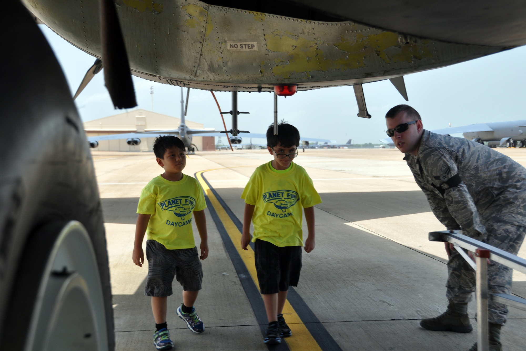 U.S. Air Force Airman 1st Class Wade Arbuckle, an Armament Systems Technician assigned to the 2nd Maintenance Squadron, shows two Planet Fun campers the antennas on the belly of a B-52. The campers toured an aircraft static display at Barksdale Air Force Base, Louisiana, July 2, 2015. (U.S. Air Force photo by Master Sgt. Laura Siebert/Released)