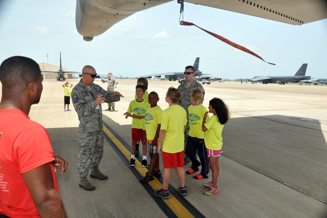 U.S. Air Force Master Sgt. Anthony Terral, 307th Bomb Wing Safety and Airman 1st Class Wade Arbuckle, an Armament Systems Technician assigned to the 2nd Maintenance Squadron, explain how chaff and flares work to deter enemy surface-to-air missiles and air-to-air missiles to a group of Planet Fun summer campers at Barksdale Air Force Base, Louisiana, July 2, 2015. (U.S. Air Force photo by Master Sgt. Laura Siebert/Released)