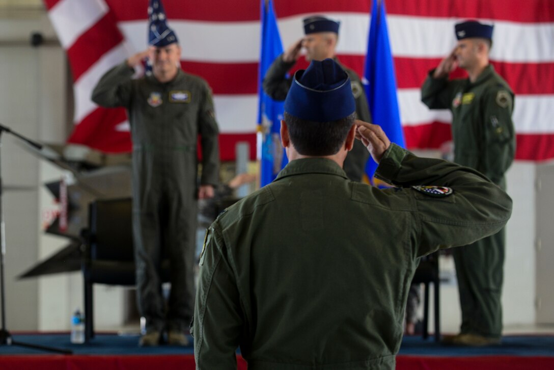 U.S. Air Force Col. Jonathan Letsinger, 1st Fighter Wing vice commander, salutes the leadership team during the 1st FW change of command ceremony at Langley Air Force Base, Va., July 10, 2015. During the ceremony, Brig. Gen. Kevin Huyck, 1st FW outgoing commander, relinquished command to Col. Pete Fesler, 1st FW incoming commander after serving at the wing for two years. (U.S. Air Force photo by Senior Airman Kimberly Nagle/Released)  
