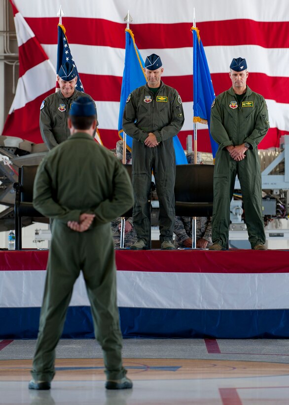 U.S. Air Force Airmen bow their heads during the 1st Fighter Wing change of command ceremony at Langley Air Force Base, Va., July 10, 2015. During the ceremony, Col. Kevin Huyck, 1st FW outgoing commander, relinquished command to Col. Peter Fesler, after serving two years. (U.S. Air Force photo by Staff Sgt. John D. Strong II/Released)

