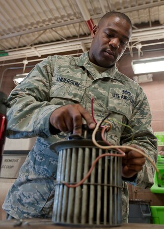Tech. Sgt. Michael Anderson, 99th Civil Engineer Squadron heating, ventilation, air conditioning and refrigeration craftsman, pulls apart a fan assembly at the 99th CES compound on Nellis Air Force Base, Nev., July 8, 2015. The HVAC/R flight is responsible for maintenance, repair, operation and installation of mechanical equipment associated with heating, ventilation, air conditioning, and refrigeration systems. (U.S. Air Force photo by Airman 1st Class Mikaley Towle)