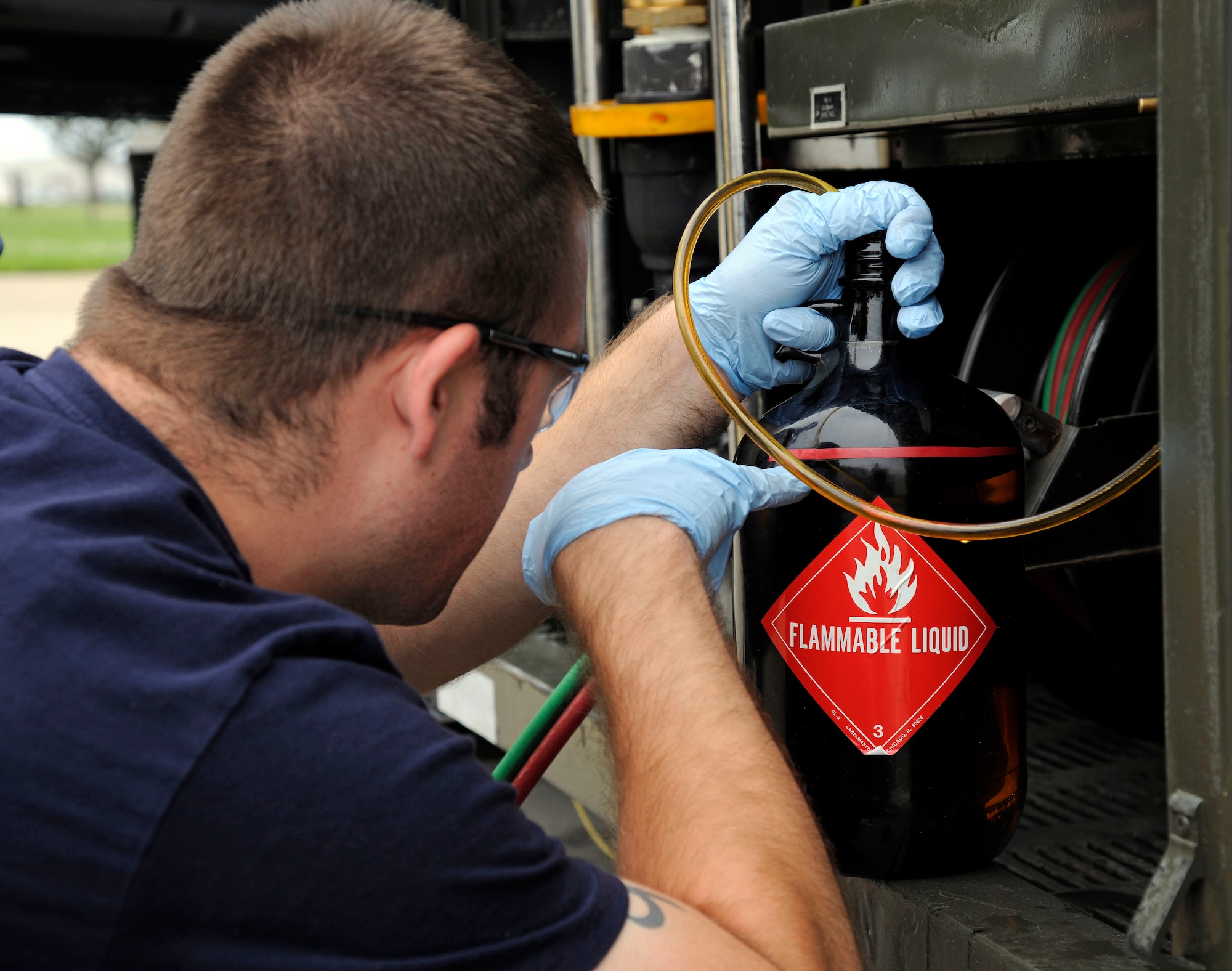 Staff Sgt. Joseph Fournier, 127th Logistics Readiness Squadron fuels distribution worker, drains fuel from a fuel truck at Selfridge Air National Guard Base, Mich., July 9, 2015. Fournier is checking to ensure the correct amount is obtained for testing. (U.S. Air National Guard photo by Senior Airman Ryan Zeski/Released)