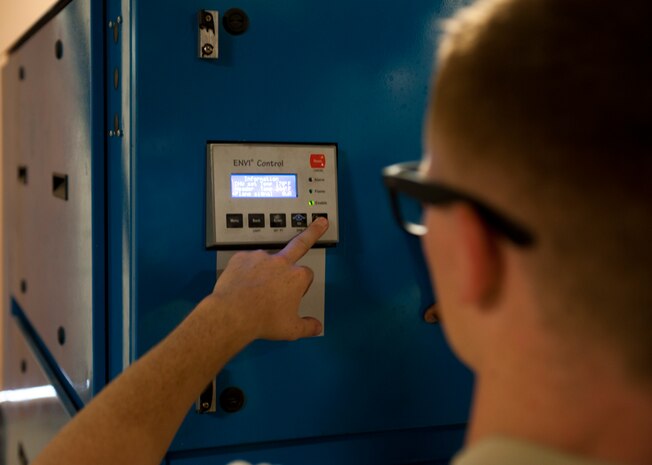 Airman 1st Class Zachery Hatfield, 99th Civil Engineer Squadron heating, ventilation, air conditioning and refrigeration journeyman, checks the settings on a boiler at the Nellis Inn on Nellis Air Force Base, Nev., July 8, 2015. This boiler is used to heat the air and water in the building. (U.S. Air Force photo by Airman 1st Class Mikaley Towle)