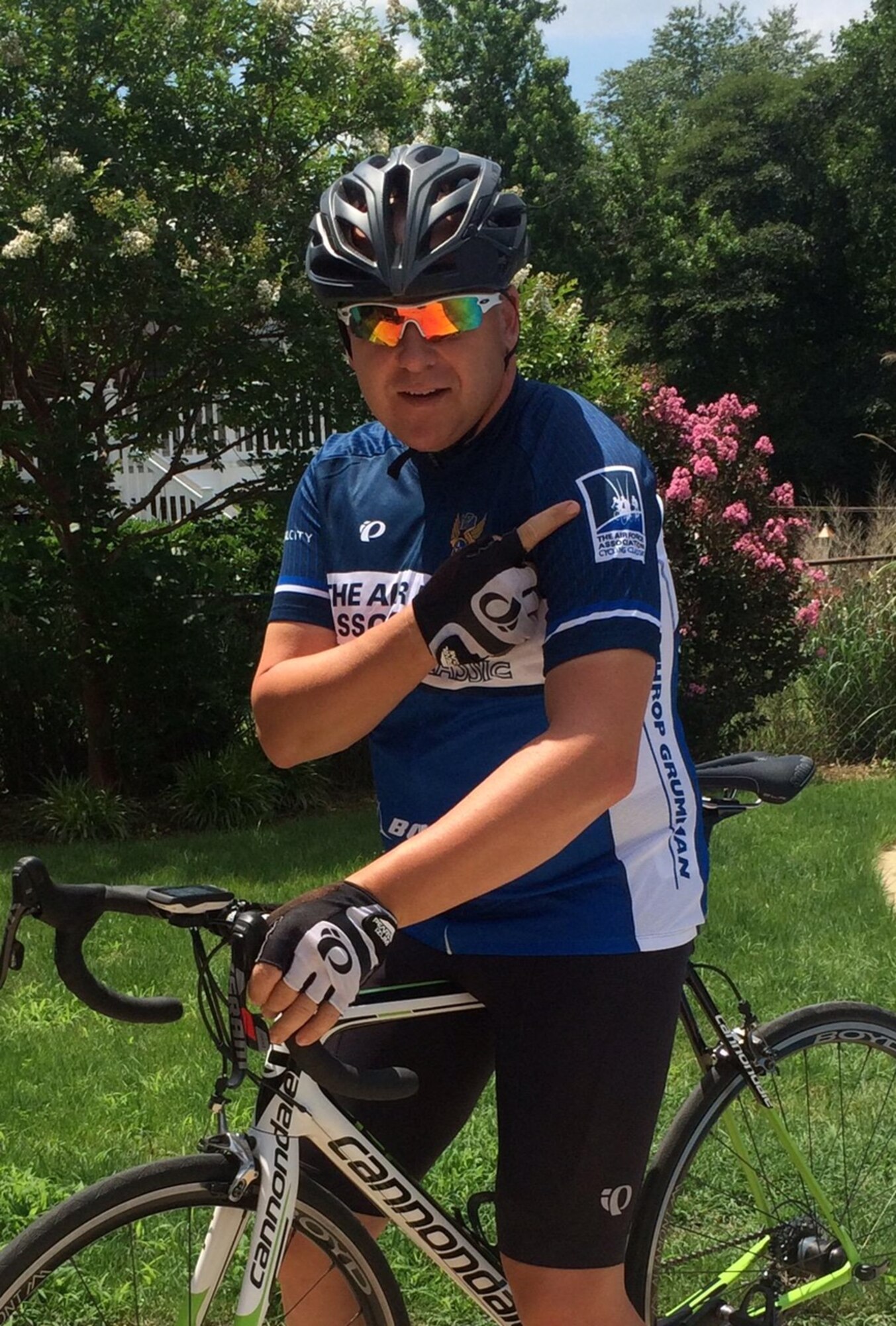Technical Sgt. Robert Smith proudly wears his Air Force Association Cycling Classic jersey while atop his racing bike. He is more than halfway towards his goal of riding 12,000 miles this year. (Photo by Paige Smith/released)
