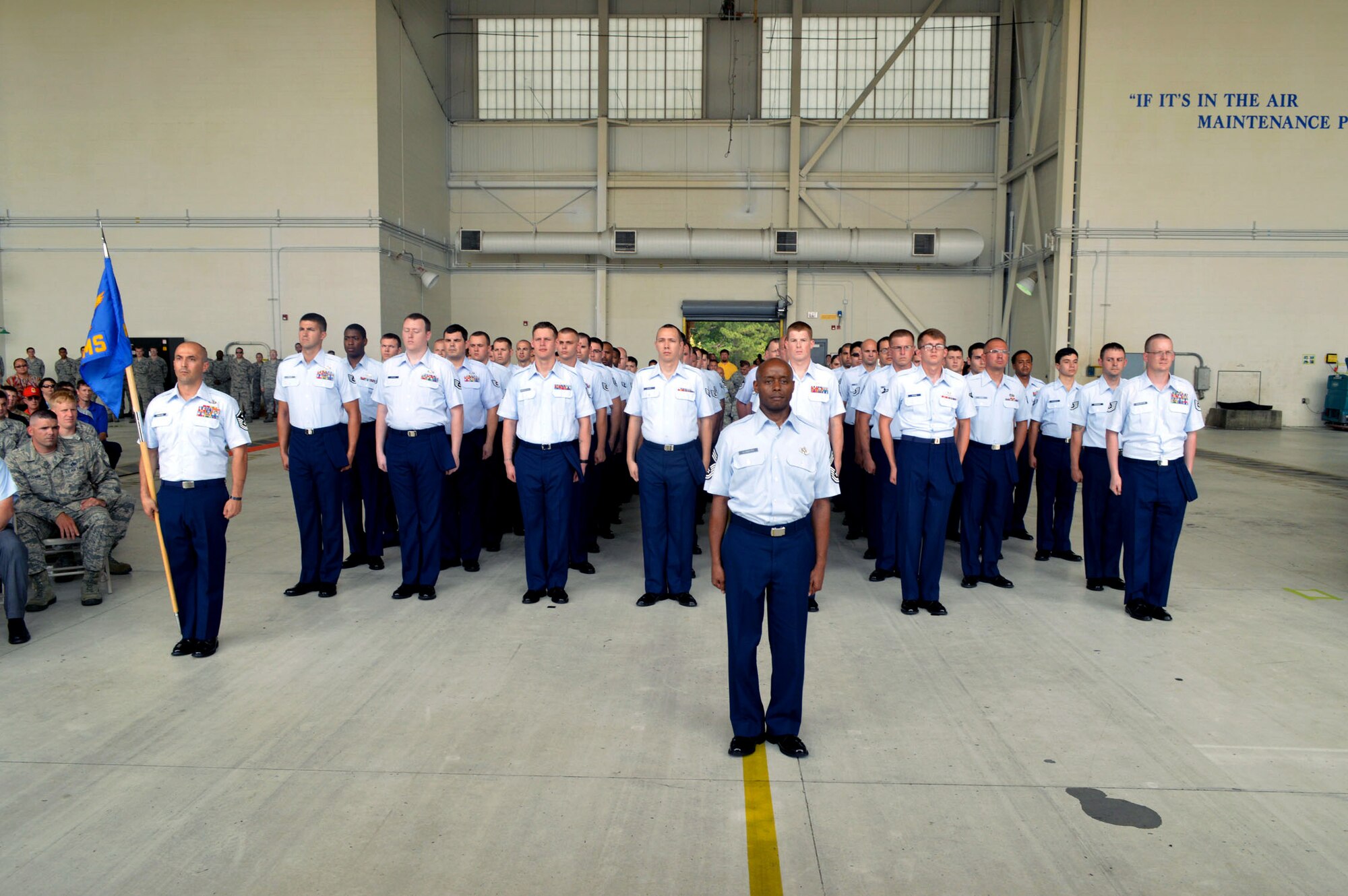 Chief Master Sgt. Kenneth Hubbard, 43rd Air Mobility Squadron superintendent, leads aircraft maintenance and aerial port Airmen who stand in formation together to form the new 43rd Air Mobility Squadron during the 43rd AMS activation ceremony July 1, 2015, at Pope Army Airfield, North Carolina. The 43rd Aircraft Maintenance Squadron and 3rd Aerial Port Squadron were inactivated and cased their guidons during the ceremony. (U.S. Air Force photo/Marvin Krause)