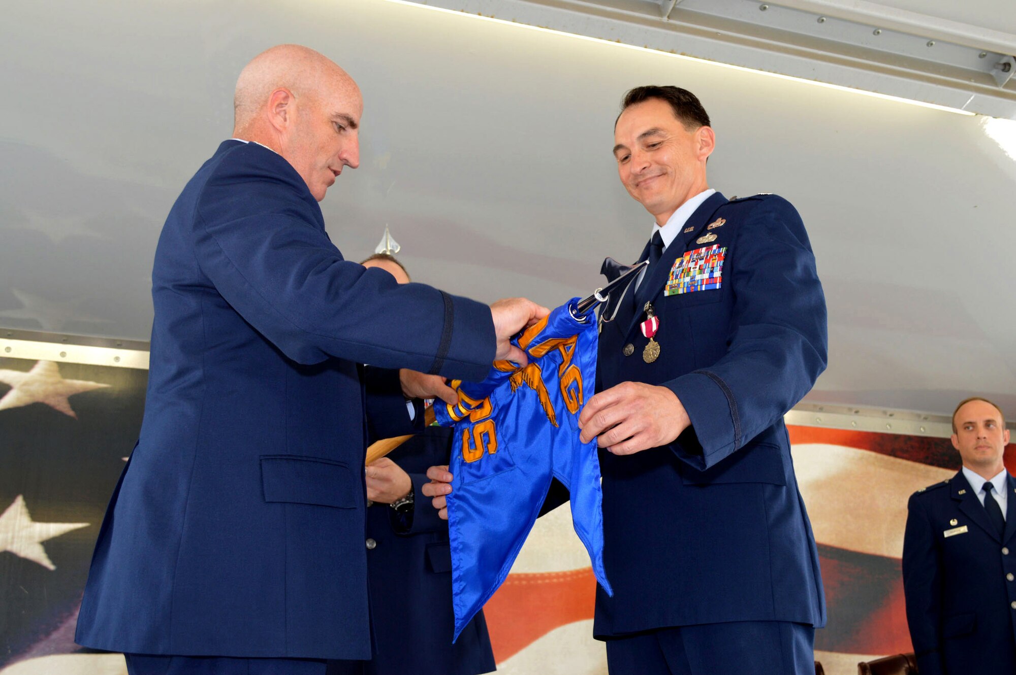 Lt. Col. Joseph Whittington Jr., 3rd Aerial Port Squadron commander, right, and Col. Kenneth Moss, 43rd Airlift Group commander, case the 3rd APS guidon during the 43rd Air Mobility Squadron activation ceremony July 1, 2015, at Pope Army Airfield, North Carolina. Aircraft maintenance and aerial port Airmen and functions transferred to the newly established 43rd AMS from the inactivated 3 APS and the 43rd Aircraft Maintenance Squadron. (U.S. Air Force photo/Marvin Krause)