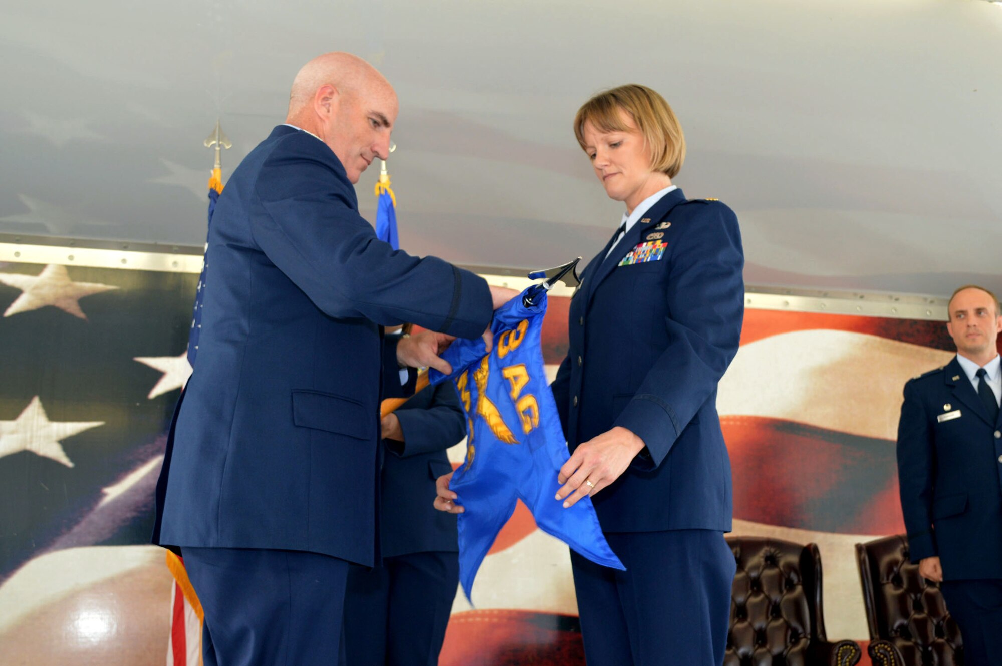 Maj. Michelle Taylor, 2nd Airlift Squadron commander, right, and Col. Kenneth Moss, 43rd Airlift Group commander, case the 43rd Aircraft Maintenance Squadron guidon during the 43rd Air Mobility Squadron activation ceremony July 1, 2015, at Pope Army Airfield, North Carolina. Aircraft maintenance and aerial port Airmen and functions transferred to the newly established 43rd AMS from the inactivated 3rd Aerial Port Squadron and the 43rd AMXS. (U.S. Air Force photo/Marvin Krause)