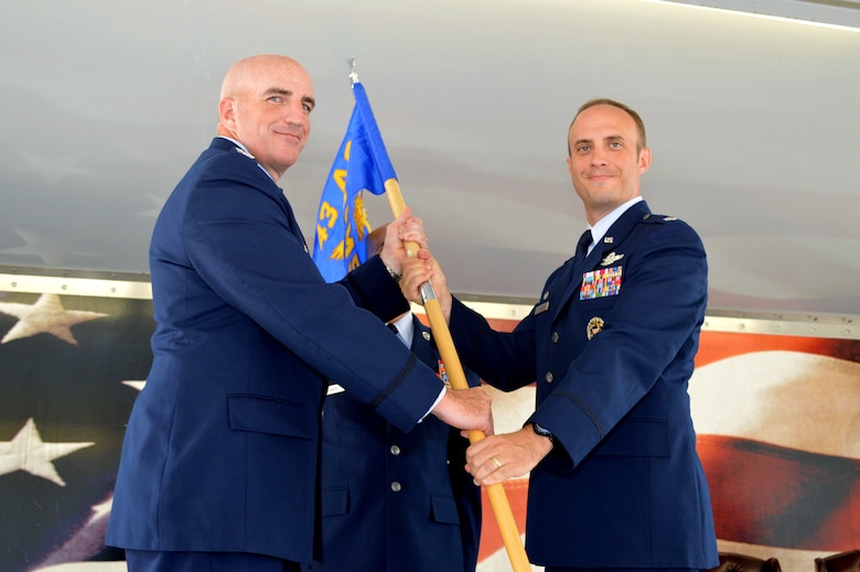Col. Kenneth Moss, 43rd Airlift Group commander, left, passes the 43rd Air Mobility Squadron guidon to Lt. Col. David Morgan during the 43rd Air Mobility Squadron activation ceremony July 1, 2015, at Pope Army Airfield, North Carolina. Morgan assumed command of the newly established squadron composed of aircraft maintenance and aerial port Airmen and functions transferred from the inactivated 43rd Aircraft Maintenance Squadron and the 3rd Aerial Port Squadron. (U.S. Air Force photo/Marvin Krause)
