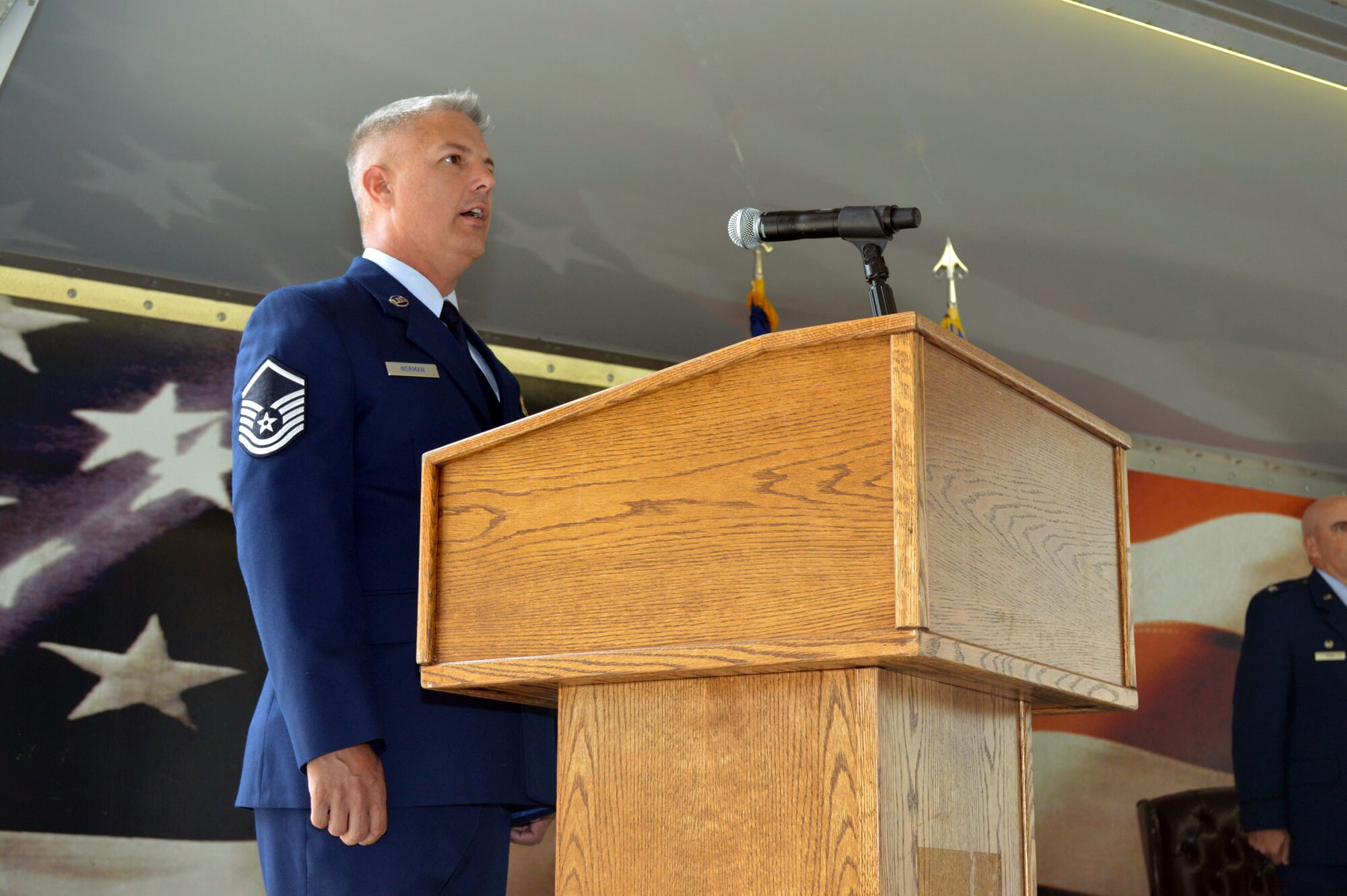 Master Sgt. John Norman II, Pope Airman and Family Readiness Center readiness, sings the National Anthem during the 43rd Air Mobility Squadron activation ceremony July 1, 2015, at Pope Army Airfield, North Carolina. Aircraft maintenance and aerial port Airmen and functions transferred to the newly established 43rd AMS from the inactivated 3rd Aerial Port Squadron and the 43rd Aircraft Maintenance Squadron. (U.S. Air Force photo/Marvin Krause)