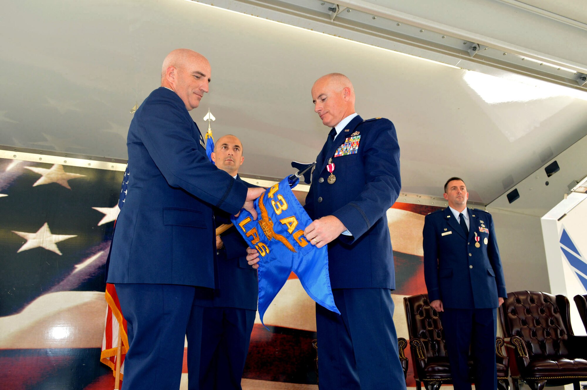 Maj. Peyton Smith, 43rd Logistics Readiness Squadron commander, right, and Col. Kenneth Moss, 43rd Airlift Group commander, case the 43rd LRS guidon during the 43rd Air Base Squadron redesignation and change of command ceremony July 1, 2015, at Pope Army Airfield, North Carolina. Logistics and force support Airmen and functions transferred to the newly established 43rd ABS from the inactivated 43rd LRS and the 43rd Force Support Squadron. (U.S. Air Force photo/Marvin Krause)