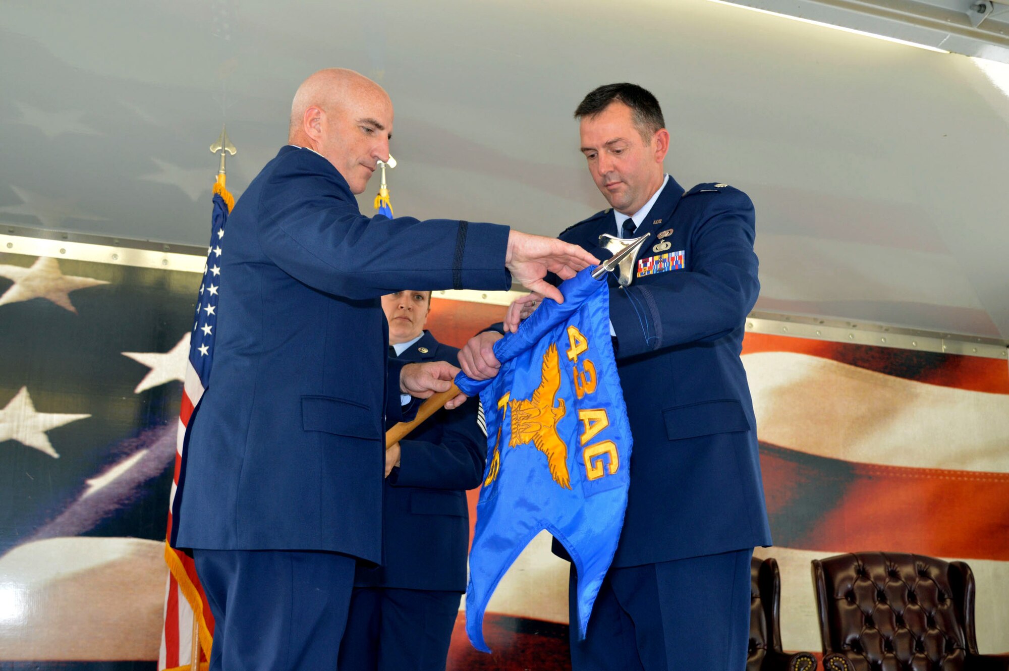 Lt. Col. Brian Ballew, 43rd Force Support Squadron commander, right, and Col. Kenneth Moss, 43rd Airlift Group commander, case the 43rd FSS guidon July 1, 2015, during the 43rd Air Base Squadron redesignation and change of command ceremony at Pope Army Airfield, North Carolina. Force support and logistics Airmen and functions transferred to the newly established 43rd ABS from the inactivated 43rd Logistics Readiness Squadron and the 43rd FSS. (U.S. Air Force photo/Marvin Krause)