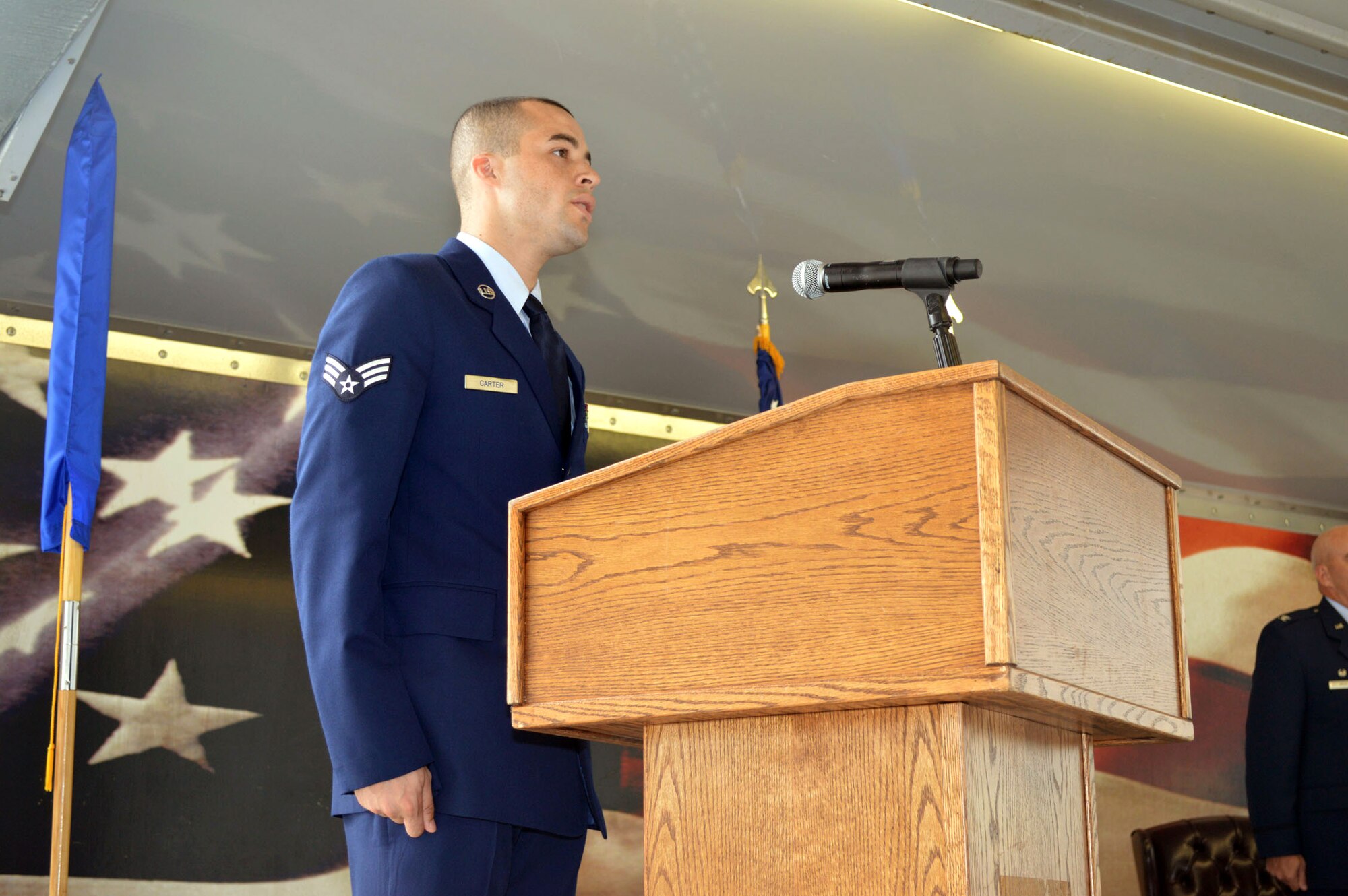 Senior Airman Anthony Carter, 43rd Air Base Squadron, sings the National Anthem during the 43rd ABS redesignation and change of command ceremony July 1, 2015, at Pope Army Airfield, North Carolina. Logistics and force support Airmen and functions transferred to the newly established 43rd ABS from the inactivated 43rd Logistics Readiness Squadron and the 43rd Force Support Squadron. (U.S. Air Force photo/Marvin Krause)