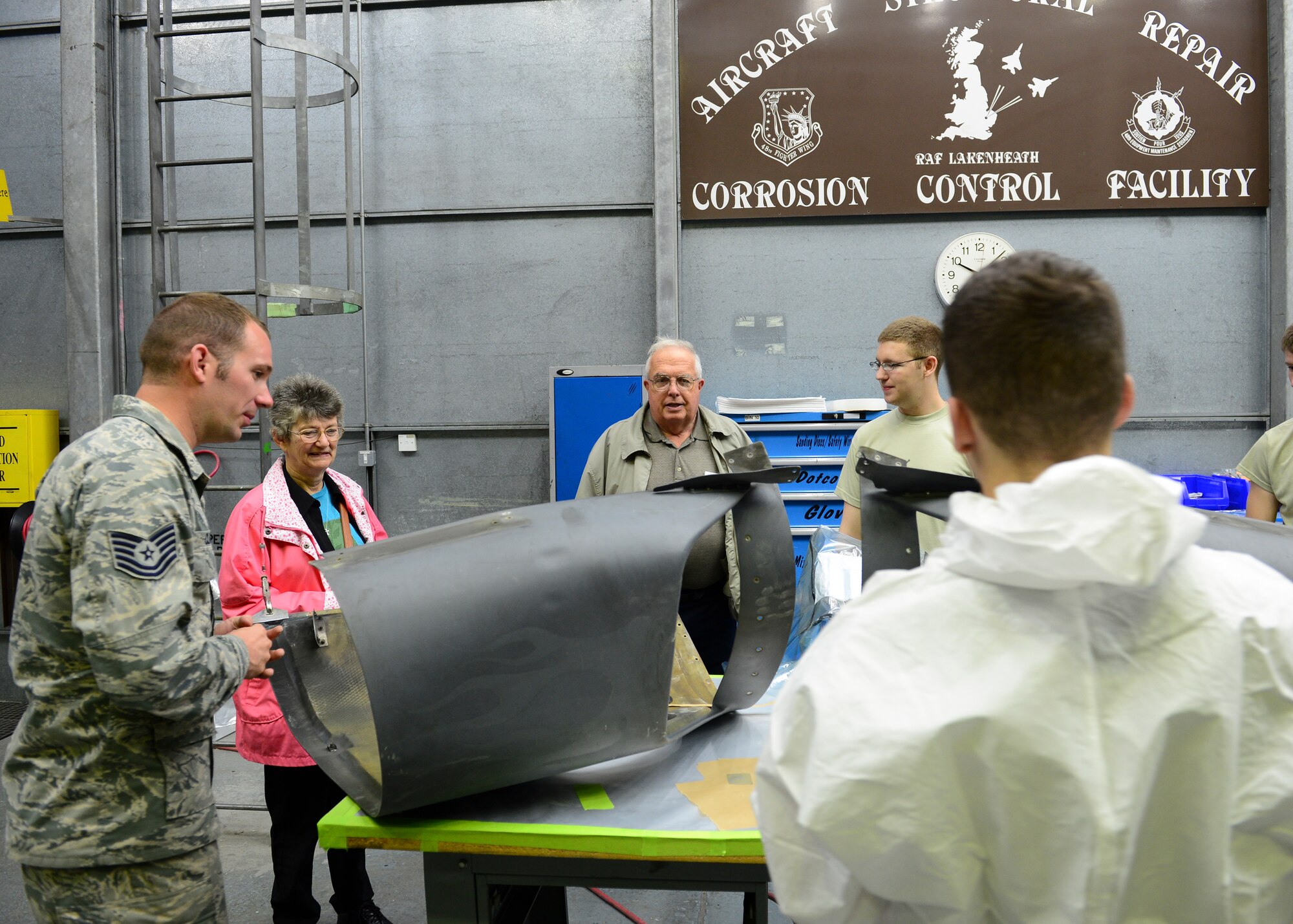 Senior Master Sgt. Robert Fluck (Ret.) speaks to 48th Equipment Maintenance Squadron corrosion control Airmen at Royal Air Force Lakenheath, July 7, 2015. As a former EMS member himself, Fluck spent the day visiting each section of the squadron learning about the new and improved capabilities, while also sharing his experiences with the young Airmen. (U.S. Air Force photo by Senior Airman Nigel Sandridge/Released)
