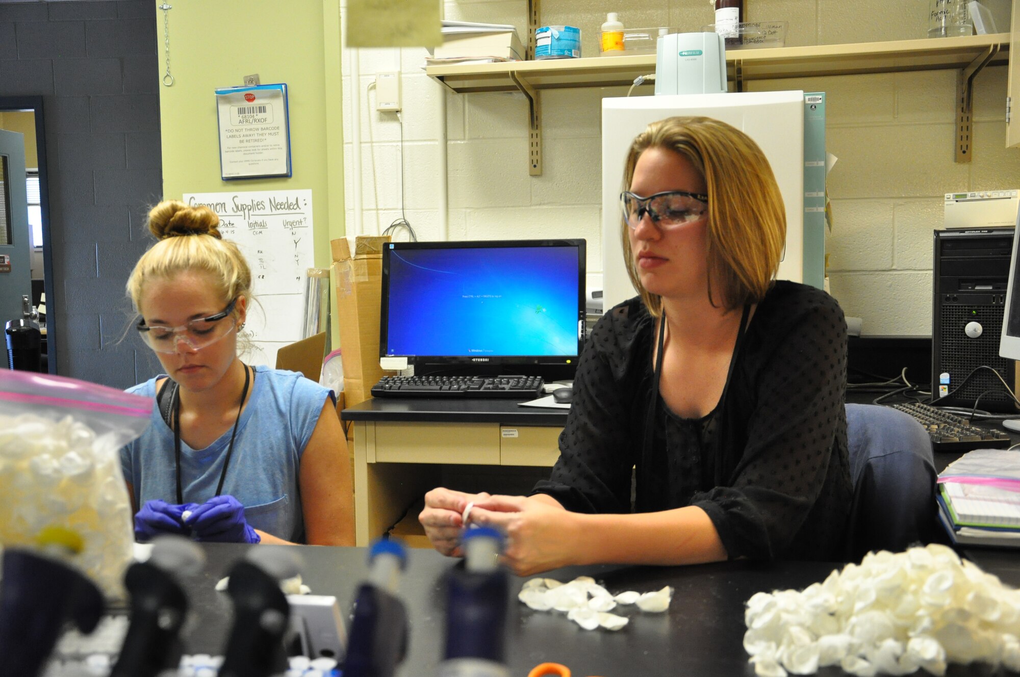 Julia Ward (left), a student attending Transylvania University in Lexington, Ky., and Chelsea Marcum, a Ph.D. student attending the University of Dayton, process silk cocoons at the Air Force Research Laboratory Materials and Manufacturing Directorate's Biological Materials Lab. The silk fibroin obtained from the cocoons is used in making biocompatible thin films to embed nanoparticles and other materials made using synthetic biology approaches. (Air Force photo by Bryan Ripple)