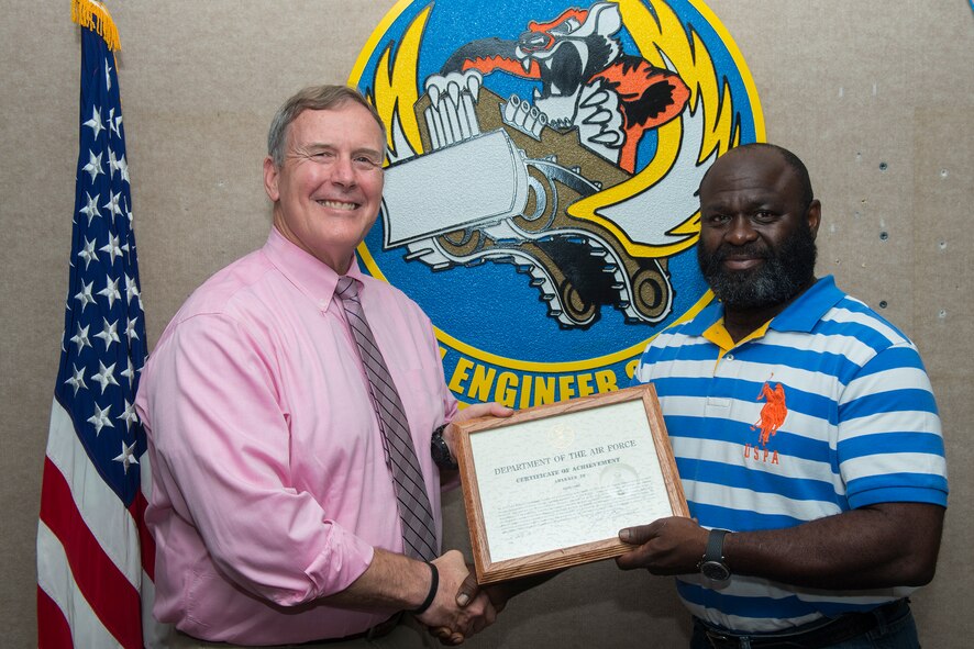 John Eunice, left, 23d Civil Engineer Squadron deputy base civil engineer, and Elvis Lane, 23d CES pollution prevention manager, pose for a photo July 8, 2015, at Moody Air Force Base, Ga. The 23d CES presented Lane with the Air Force Civilian Certificate of Achievement Award for correctly refuting an inspector’s write up and preventing Moody from an unnecessary violation. (U.S. Air Force Airman 1st Class Ceaira Tinsley/Released)