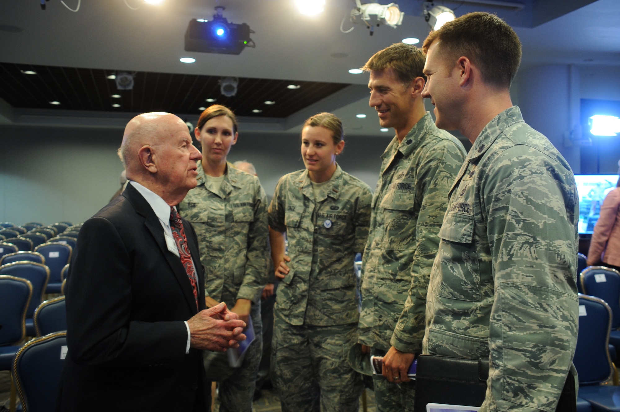 A group of current Defense Meteorological Satellite Program officers meet with 94-year-old retired Air Force Col. Thomas Haig, the former DMSP director who created and managed the program when the National Reconnaissance Office established a meteorological satellite program in 1961. Haig is one of six early Air Force and civilian space pioneers who were honored during a ceremony unveiling their newly inscribed names on a wall of polished black granite at the General Bernard A. Schriever Memorial. The memorial and wall of honor are located on the grounds of the Space and Missile Systems Center at Los Angeles Air Force Base in El Segundo, Calif. (U.S. Air Force photo/Van Ha)