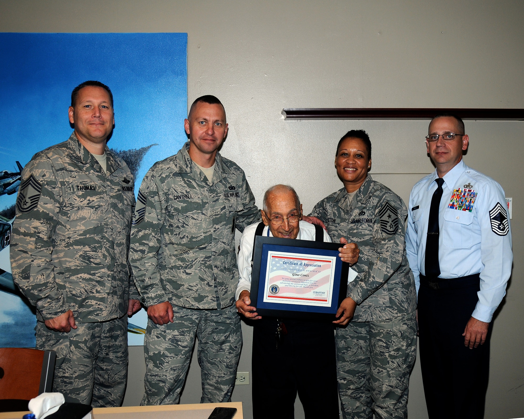 Retired Chief Master Sgt. Gino Conti poses for a photo with Chief Master Sgts. Mike Thomas, Mark Cantrell, Allen Markle and Command Chief Rita Felton July 7 on Columbus Air Force Base. Conti visited the base for lunch, but was surprised by Pam Foster, Director of Hospice, Baptist Hospice, who presented him with a certificate of appreciation to pay special tribute for his nearly 31 years of military service. (U.S. Air Force photo/Sharon Ybarra)