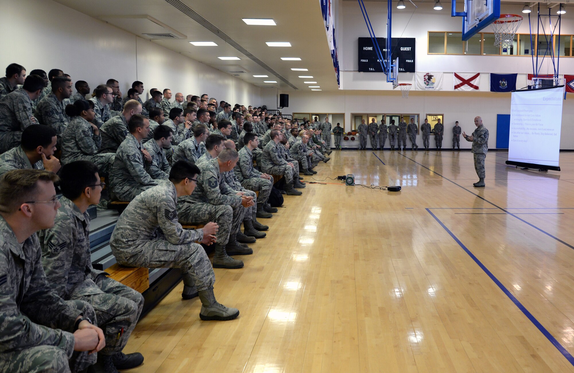 U.S. Air Force Chief Master Sergeant Anthony Cruz-Munoz, 100th Air Refueling Wing command chief, briefs Airmen during his first enlisted call July 9, 2015, at the Hardstand Fitness Center on RAF Mildenhall, England. Cruz-Munoz gave Team Mildenhall Airman a better understanding of who he is and his expectations as command chief. (U.S. Air Force photo by Senior Airman Christine Halan/Released)