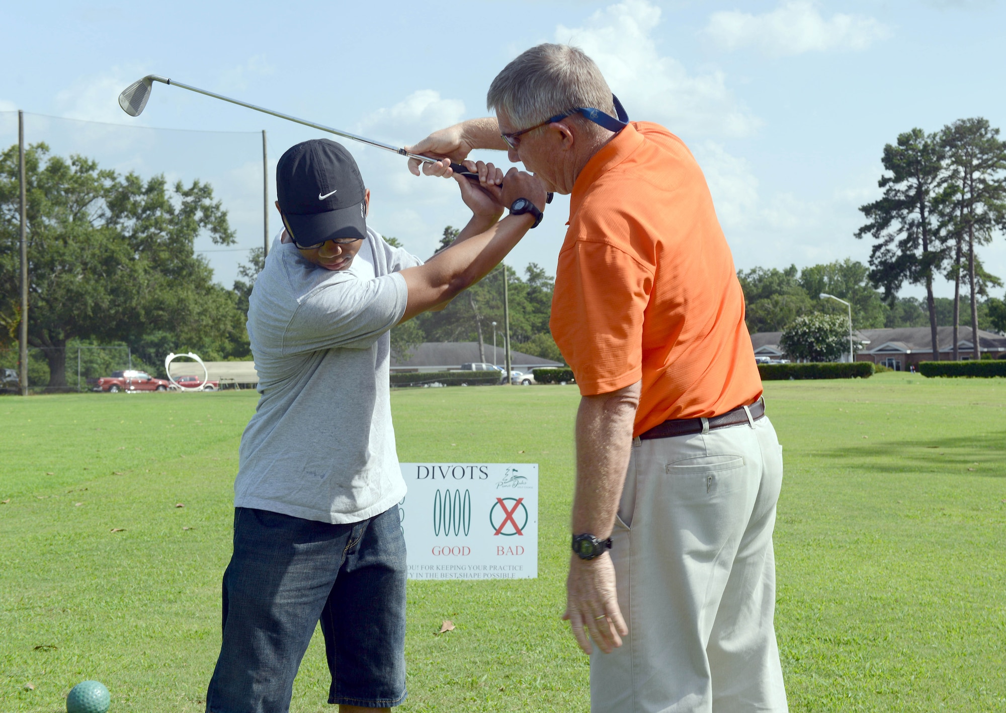 Daniel Brewer, 5th Combat Communications Support Squadron vehicle maintenance technician, receives golf tips from Mike Baker, Pine Oaks Golf Course manager. The facility offers “Tips from the Pro” on Tuesdays from 5 to 6 p.m. (U.S. Air Force photo by Tommie Horton)