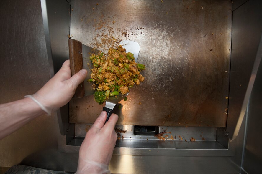 Staff Sgt. Ryan Patriok, 5th Force Support Squadron missile chef, prepares ingredients for stir-fry at the Bravo 01 Missile Alert Facility, July 1, 2015. Missile chefs follow recipe cards for meals that outline portion sizes and ingredient measurements and also add their personal flare to presentation and flavor. (U.S. Air Force photo/Senior Airman Stephanie Morris)