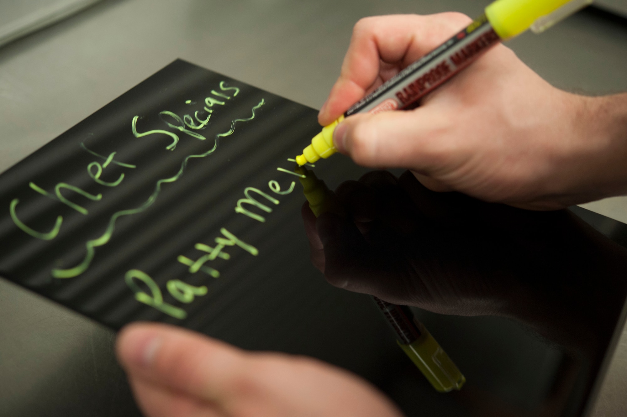 Staff Sgt. Ryan Patriok, 5th Force Support Squadron missile chef, writes his chef’s specials on a marker board at the Bravo 01 Missile Alert Facility, July 1, 2015. Over time missile chefs develop ways to prepare food with their own personal flare and create their own meal specials. (U.S. Air Force photo/Senior Airman Stephanie Morris)