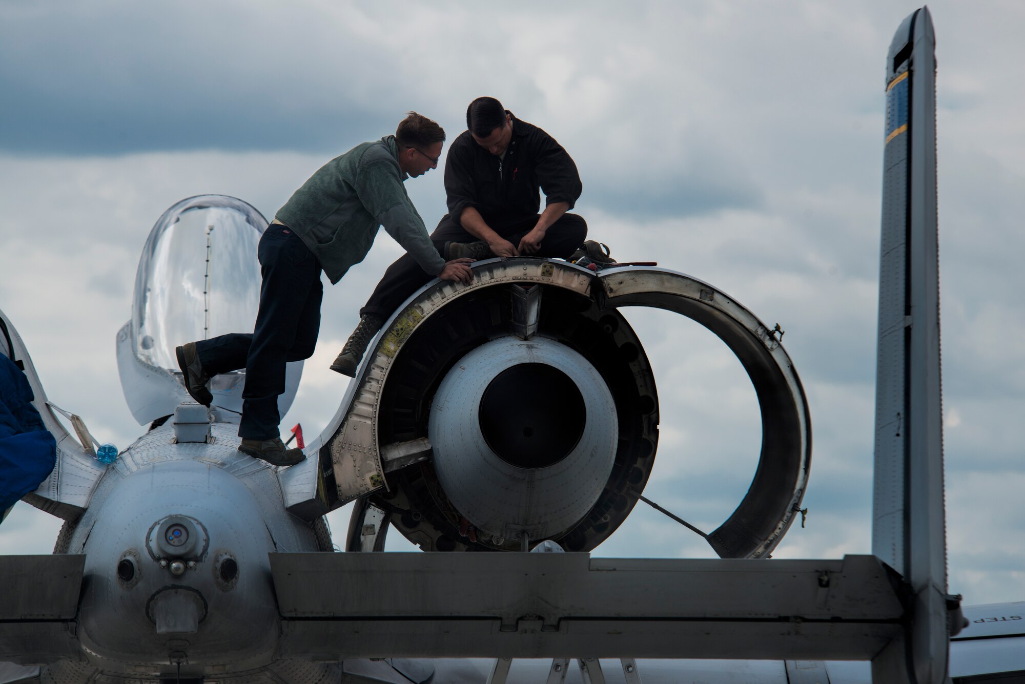 U.S. Air Force crew chiefs from the 354th Expeditionary Fighter Squadron perform maintenance on a U.S. Air Force A-10 Thunderbolt II attack aircraft engine during a theater security package deployment to Lask Air Base, Poland, July 9, 2015. The U.S. and Polish air forces will conduct training aimed to strengthen interoperability and demonstrate the countries' shared commitment to the security and stability of Europe. (U.S. Air Force photo by Staff Sgt. Christopher Ruano/Released)