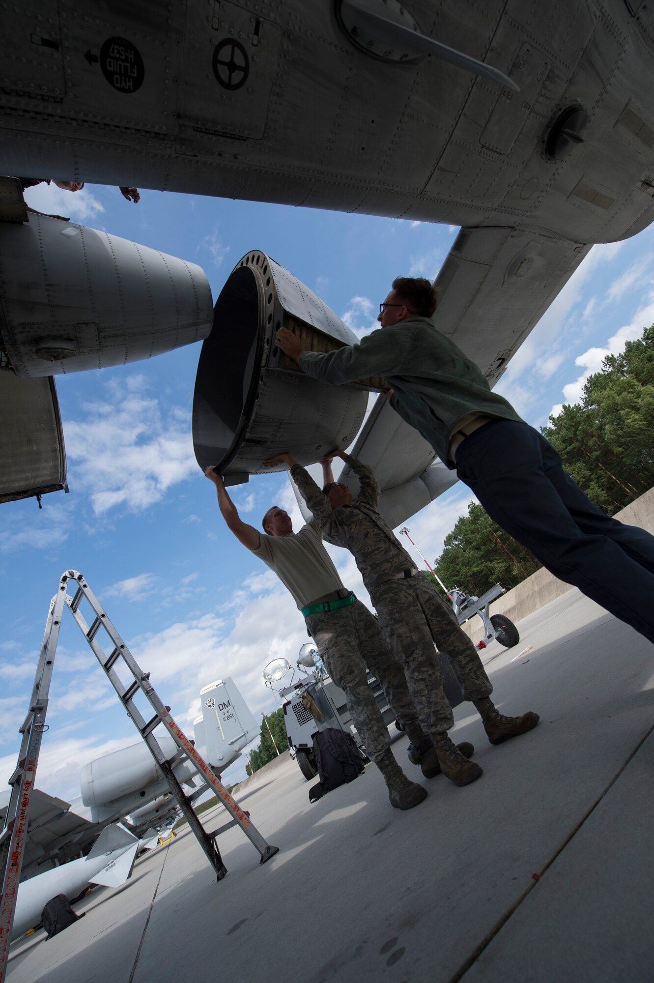 Maintainers from the 354th Expeditionary Fighter Squadron hoist up a part of a U.S. Air Force A-10 Thunderbolt II attack aircraft engine during a theater security package deployment to Lask Air Base, Poland, July 9, 2015. The U.S. and Polish air forces will conduct training aimed to strengthen interoperability and demonstrate the countries' shared commitment to the security and stability of Europe.  (U.S. Air Force photo by Staff Sgt. Christopher Ruano/Released)