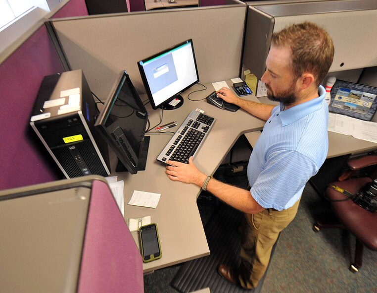 Bryan Canady, Air Force Life Cycle Management Center contracting specialist, performs his job while standing at the computer. Several of Canady’s coworkers have adopted this type workplace arrangement for its health benefits. (U.S. Air Force photo by Tommie Horton)