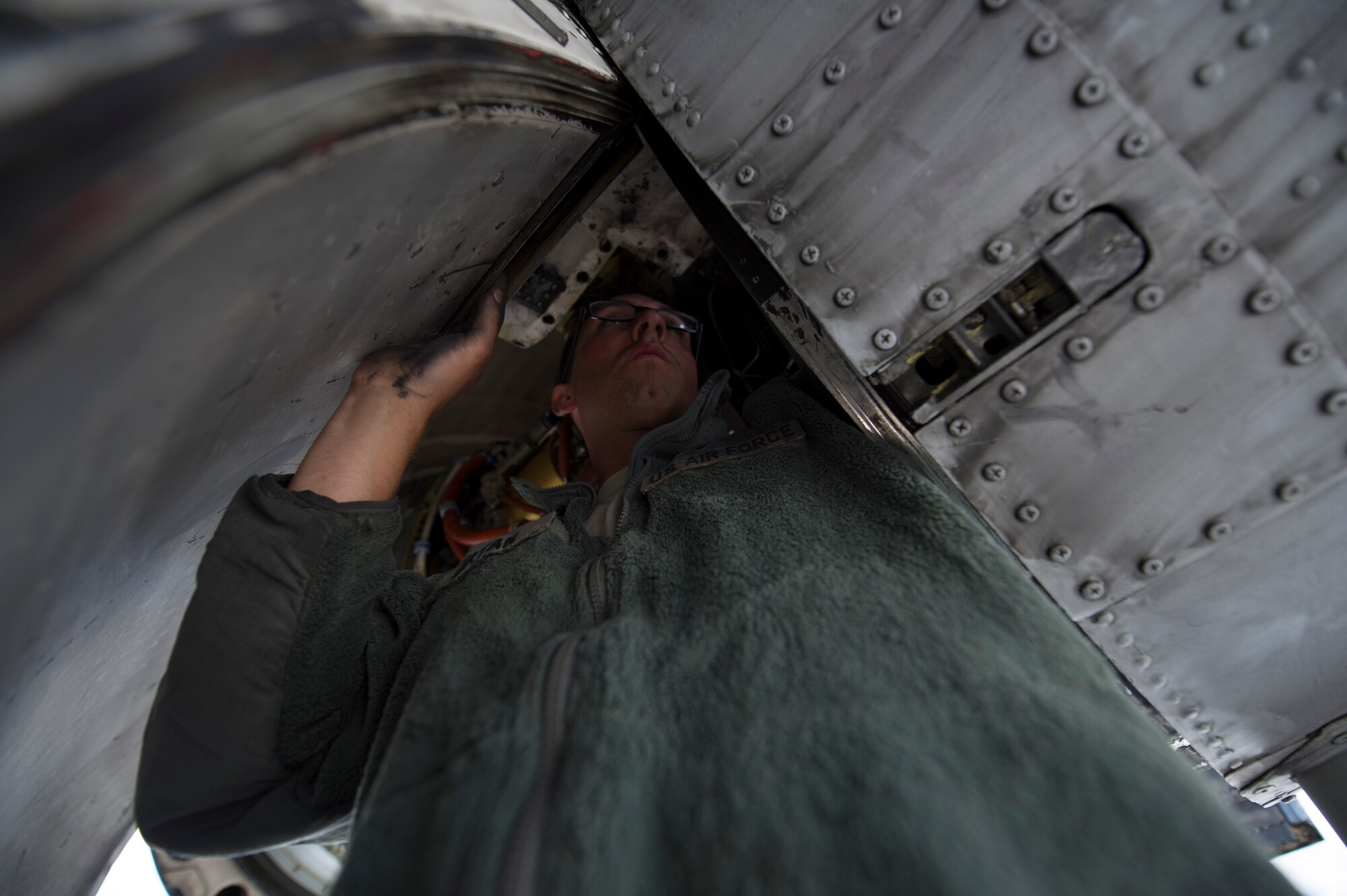 A U.S. Air Force 354th Expeditionary Fighter Squadron crew chief inspects the engine of a U.S. Air Force A-10 Thunderbolt II attack aircraft during a theater security package deployment Lask Air Base, Poland, July 9, 2015. U.S. Air Force Airmen conduct training alongside NATO allies to strengthen interoperability and demonstrate U.S. commitment to the security and stability of Europe. (U.S. Air Force photo by Staff Sgt. Christopher Ruano/Released)