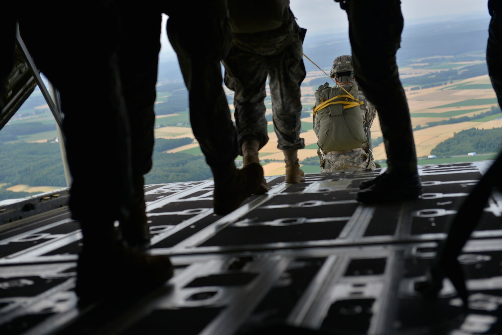 Paratroopers exit a C-130J Super Hercules during International Jump Week July 9, 2015, at Ramstein Air Base, Germany. The 435th Contingency Response Group invited nine allied nations to participate in International Jump Week to boost camaraderie and learn how to work together. (U.S. Air Force photo/Airman 1st Class Lane T. Plummer)