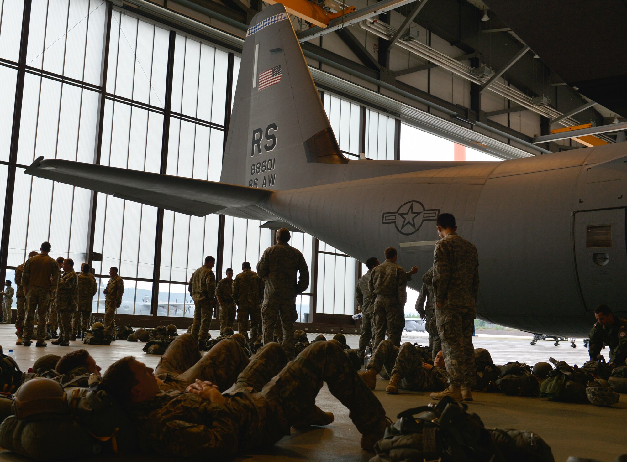 Paratroopers from nine countries check their equipment and prepare to exit a C-130J Super Hercules July 9, 2015 at Ramstein Air Base, Germany. U.S. Air Force and Army service members worked alongside nine allied countries’ militaries to increase interoperability and strengthen partnerships. (U.S. Air Force photo/Airman 1st Class Lane T. Plummer)