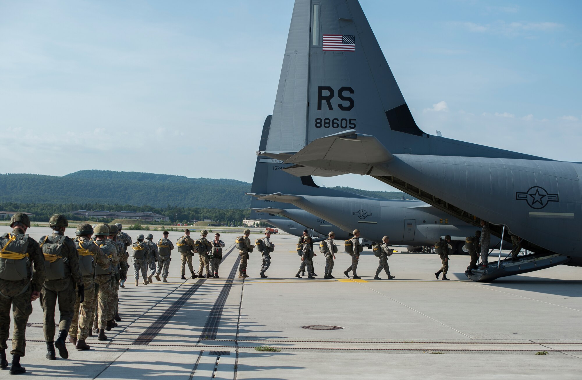 Paratroopers from multiple allied countries enter a C-130J Super Hercules during International Jump Week, July 7, 2015 at Ramstein Air Base, Germany. The five-day event was led by the 435th Contingency Response Group and gave multiple nations the opportunity to work side-by-side, increasing interoperability and strengthening relationships. (U.S. Air Force photo/Senior Airman Damon Kasberg)