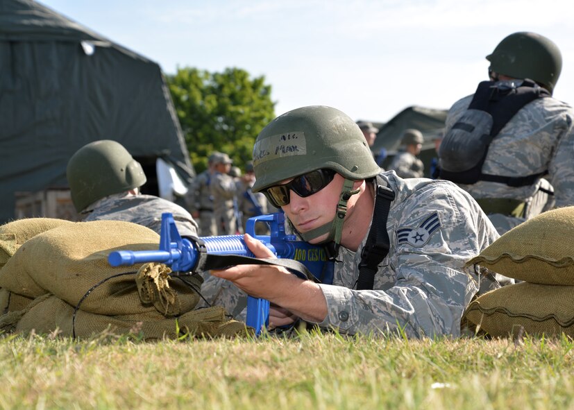 U.S. Air Force Senior Airman Maxwell Davis, 100th Civil Engineer Squadron Pavements and Construction journeyman from Bakersfield, Calif., sets up a defensive fighting position while covering sectors during 100th CES bivouac training June 25, 2015, on RAF Mildenhall, England. During the training, 100th CES Airmen learned expedient construction techniques and proper position arrangements to provide security for an encampment or worksite. (U.S. Air Force photo by Karen Abeyasekere/Released)
