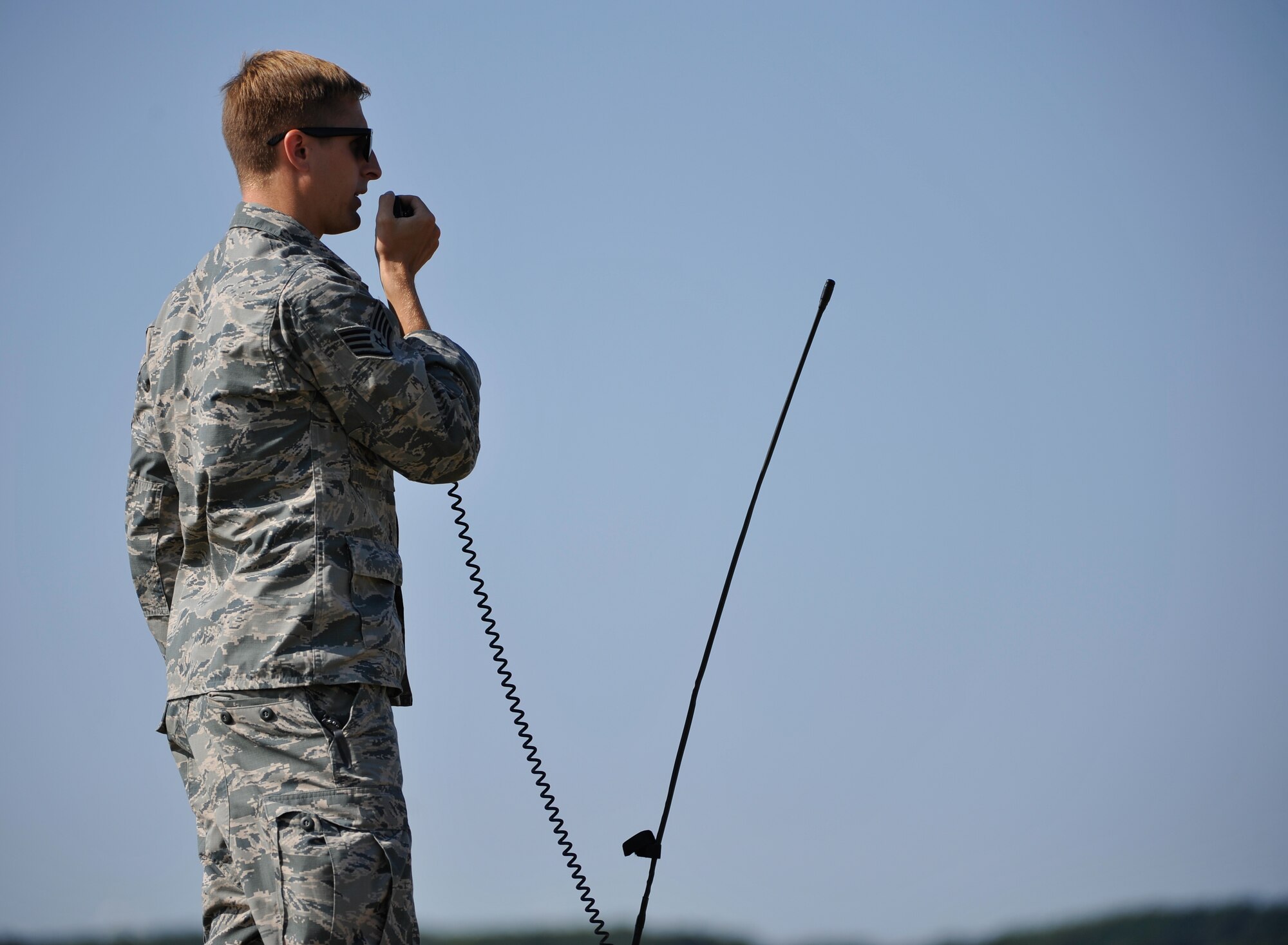 Staff Sgt. Luke Hightower, 435th Contingency Response Group air traffic controller, requests for the estimated drop time of paratroopers from a C-130J Super Hercules during International Jump Week near Alzey, Germany, July 7, 2015. Hightower’s responsibility during the event was to monitor wind speeds at the drop zones, ensuring the safety of more than 200 international and U.S. paratroopers. (U.S. Air Force photo/Staff Sgt. Leslie Keopka)