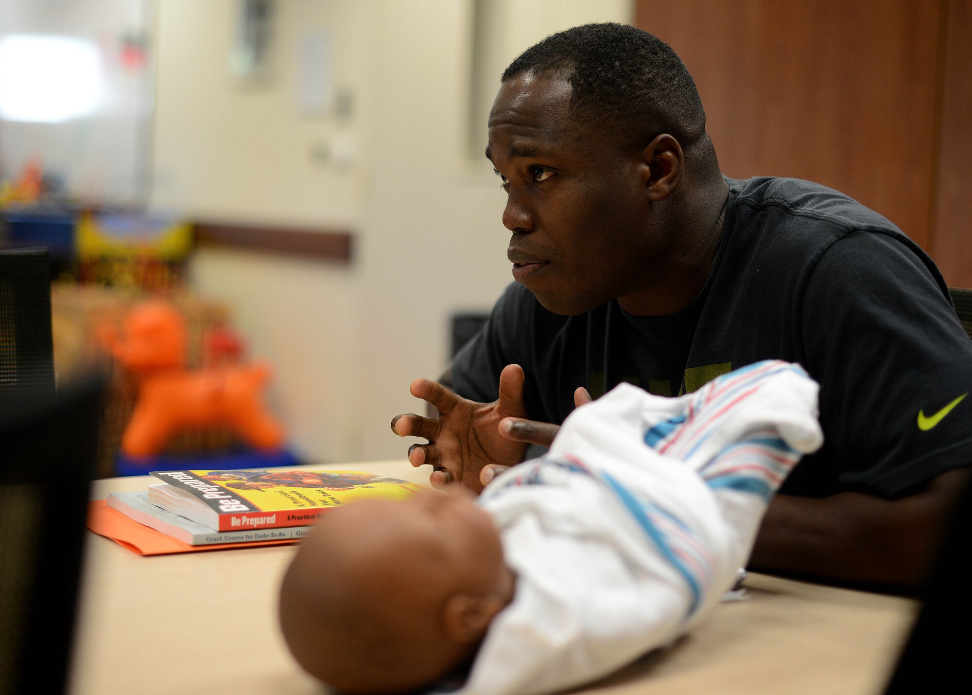 U.S. Air Force Senior Airman Walker Jeanphilippe talks about his fatherhood experiences during the Daddy Boot Camp course July 8, 2015, at Aviano Air Base, Italy.  Aviano’s Family Advocacy hosts the course every first Tuesday of the month for new or expectant fathers. (U.S. Air Force photo by Staff Sgt. Evelyn Chavez)