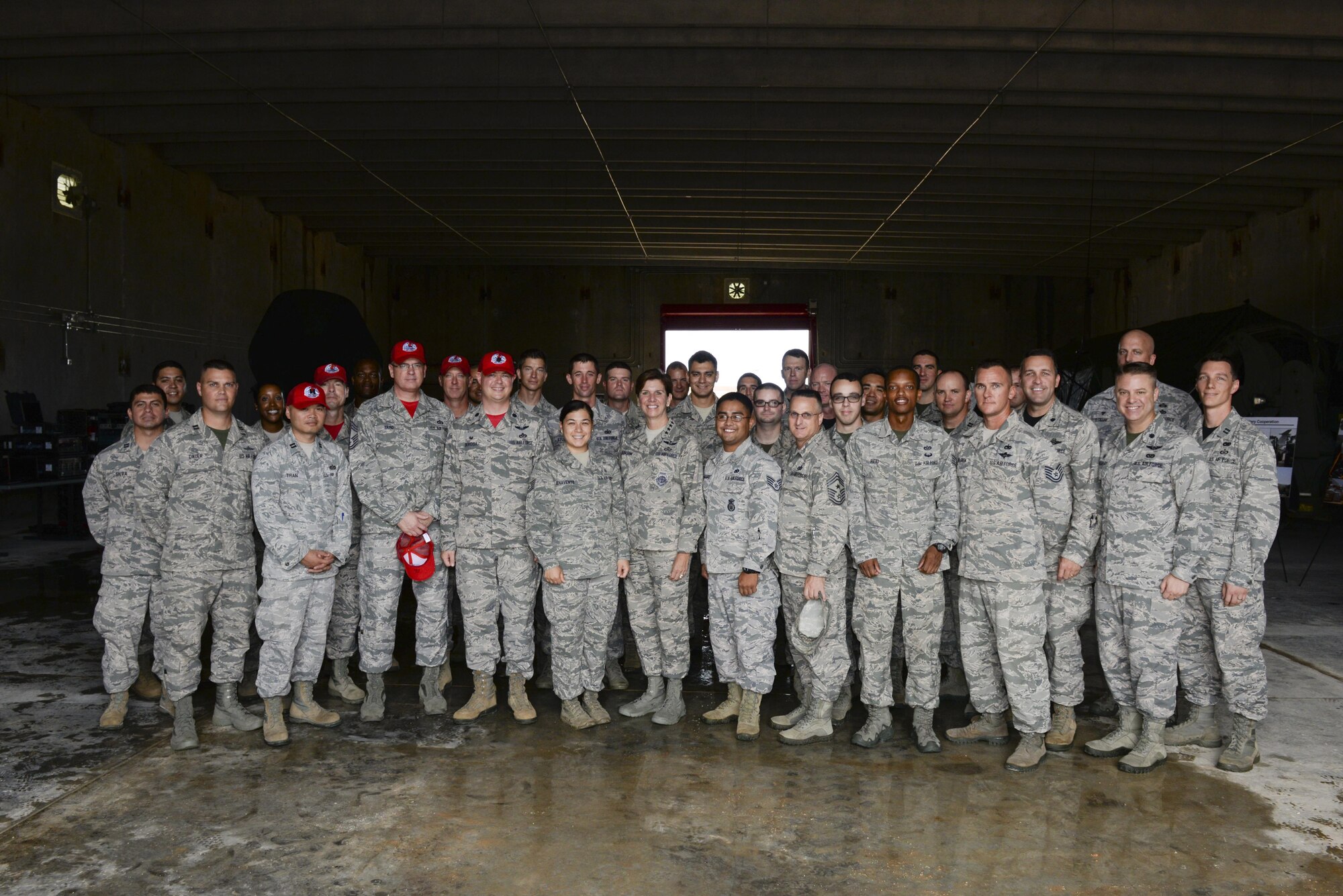 U.S. Air Force Gen. Lori Robinson, Pacific Air Forces commander, and Chief Master Sgt. Harold Hutchison, PACAF command chief, stand with Airmen assigned to the 36th Contingency Response Group, July 10, 2015, Andersen Air Force Base, Guam. During their visit to the base, Robinson and Hutchinson met with Airmen and families to receive a firsthand look how Airmen stationed in Guam contribute to regional security. (U.S. Air Force photo by Senior Airman Alexander W. Riedel/Released)