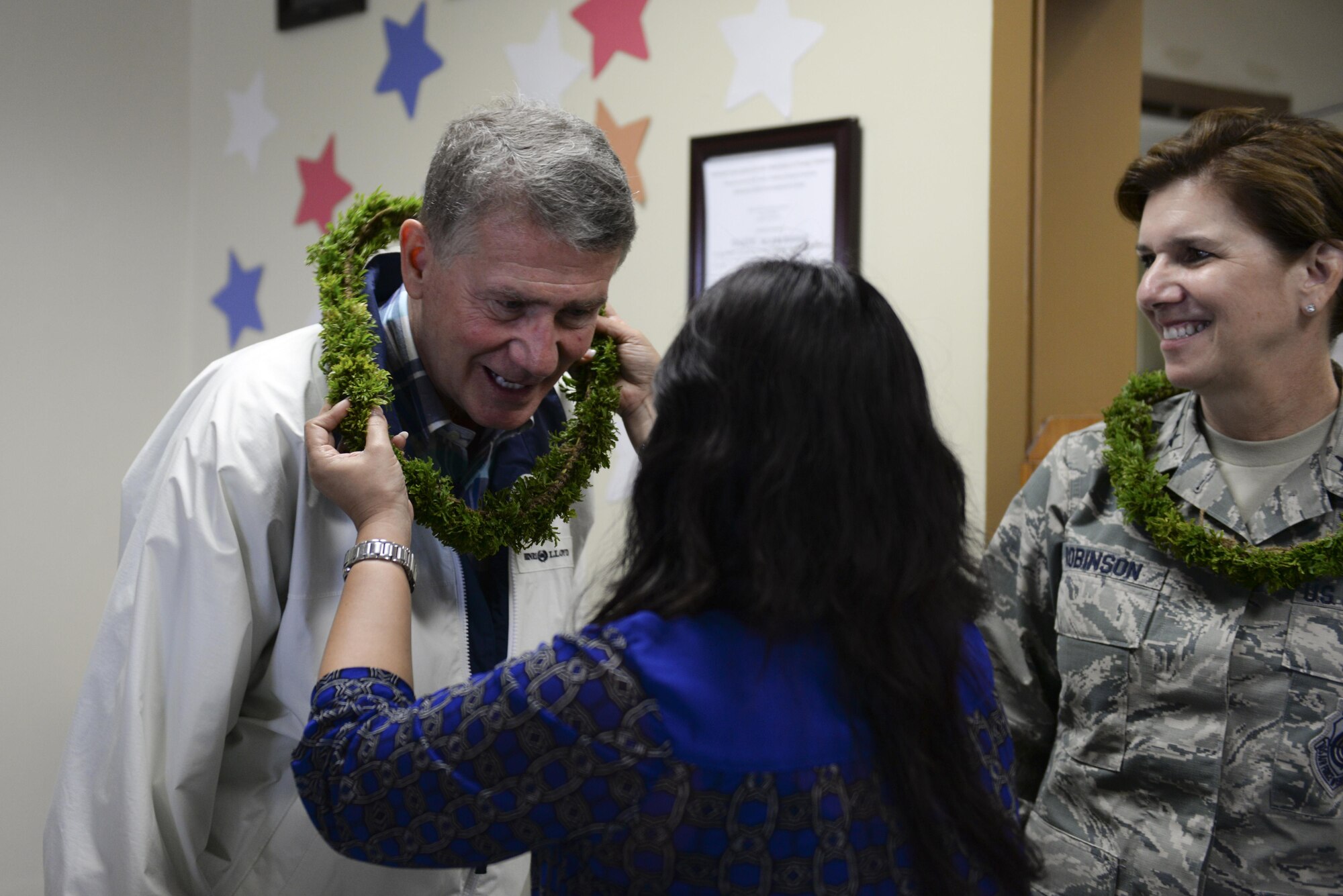 Retired Air Force Maj. Gen. David Robinson receives a lei during his visit to Andersen’s Child Development Center with U.S. Air Force Gen. Lori Robinson, Pacific Air Forces commander, July 10, 2015, Andersen Air Force Base, Guam. During their visit to the island, Robinson toured various facilities to include the Airman and Family Readiness Center and U.S. Naval Hospital to receive a firsthand look how Airmen stationed in Guam contribute to regional security. (U.S. Air Force photo by Senior Airman Alexander W. Riedel/Released)