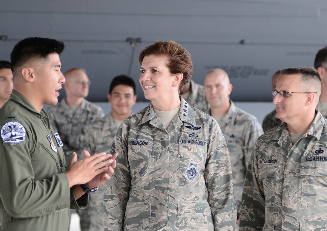 U.S. Air Force Gen. Lori Robinson, Pacific Air Forces commander, and Chief Master Sgt. Harold Hutchison, PACAF command chief, interact with Airmen assigned to the 20th Expeditionary Bomb Squadron, July 9, 2015, Andersen Air Force Base, Guam. During their visit to the base, Robinson and Hutchinson met with Airmen and families to receive a firsthand look at how Airmen stationed in Guam contribute to regional security. (U.S. Air Force photo by Senior Airman Alexander W. Riedel/Released)