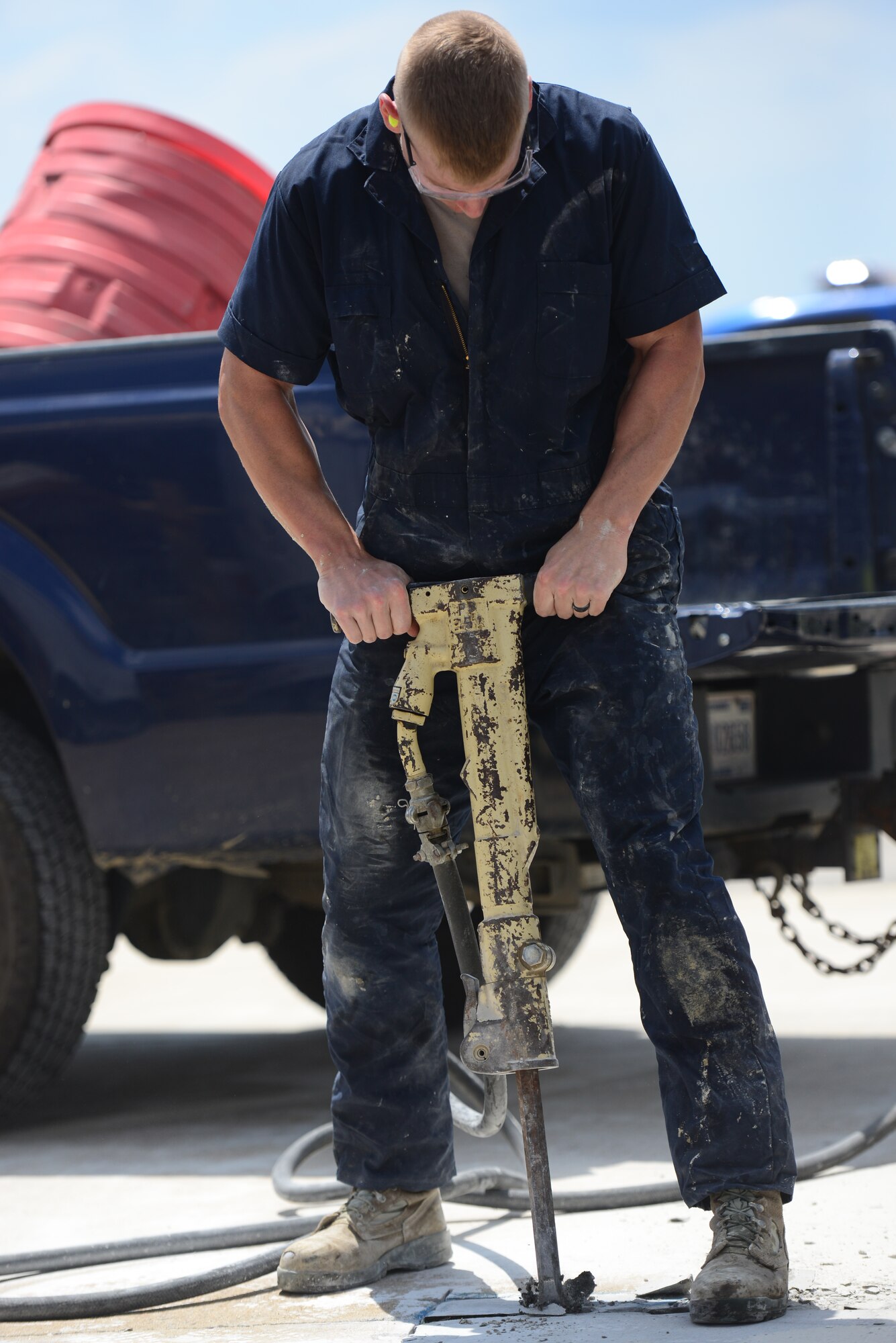 Airman 1st Class Zachary Downing, 51st Civil Engineer Squadron pavement and construction equipment apprentice, jackhammers out a broken section of pavement before the mixing, pouring, and finishing of the new concrete patch can begin on the airfields of Osan Air Base, Republic of Korea, June 27, 2015. As a member of the group known as the "Dirt Boyz," Downing is trained to operate a vast array of heavy machinery.
(USAF photo by Staff Sgt. Amber Grimm)