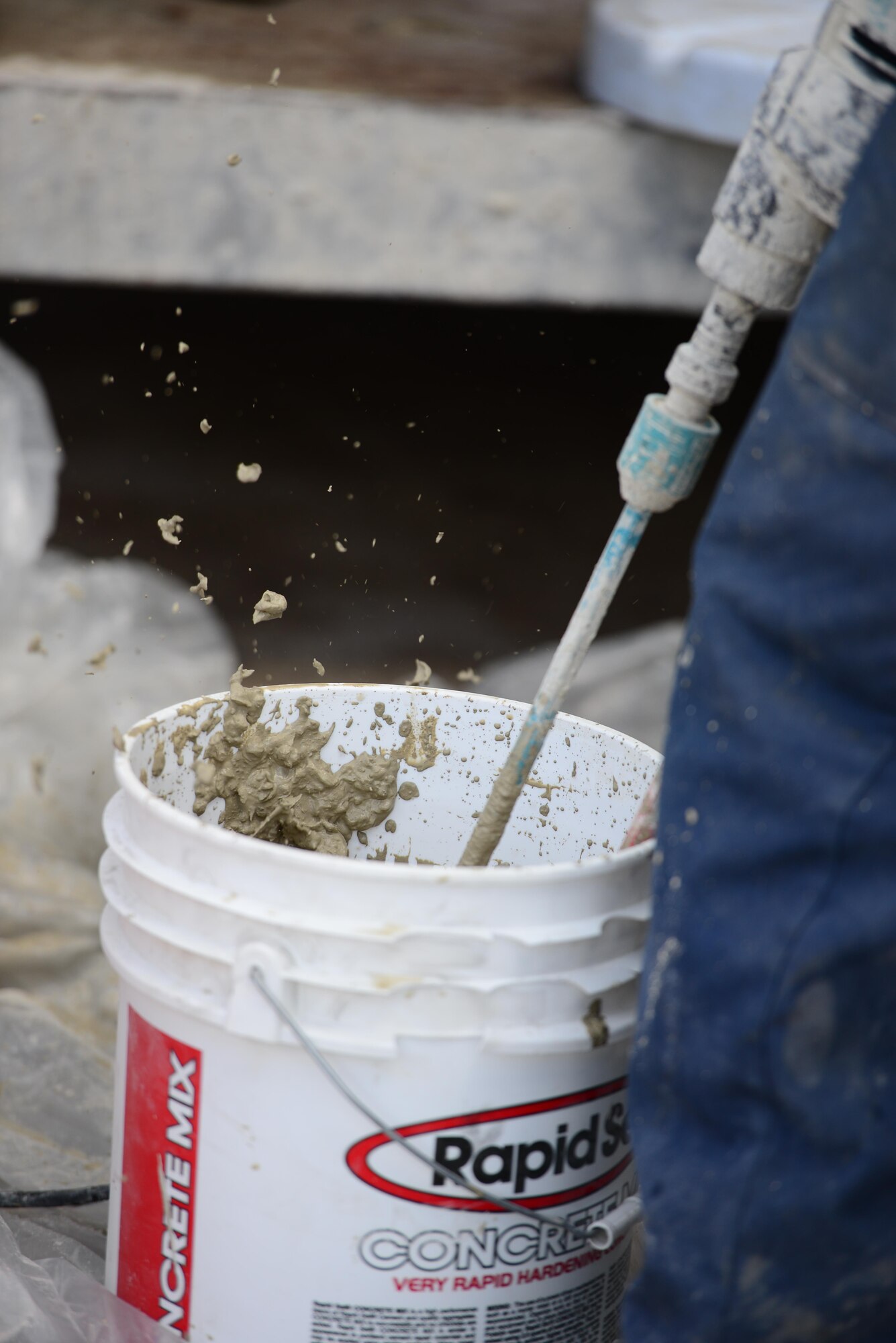 Concrete flies as Airmen from the 51st Civil Engineer Squadron pavement and construction equipment shop, also knowns as the "Dirt Boyz," prepare to perform spot repairs on sections of airfield at Osan Air Base, Republic of Korea, June 27, 2015. Since January 1, 2015 the "Boyz" have logged over 3,000 man hours completing more than 2,000 such repairs on the 1.5 million square yards of Osan's airfield. 
(USAF photo by Staff Sgt. Amber Grimm)