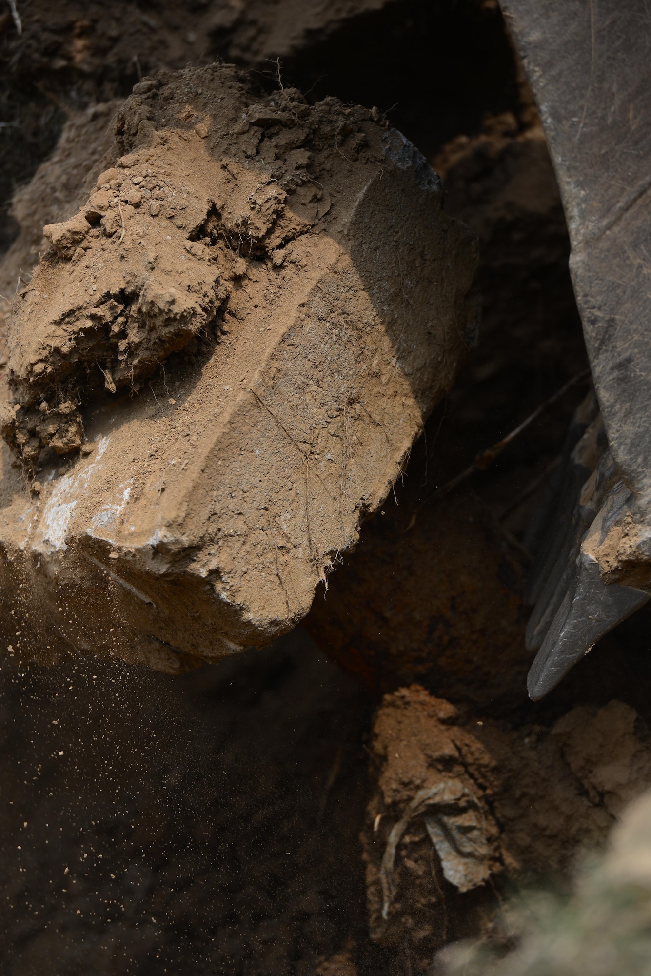 Using a backhoe a team of Airmen from the 51st Civil Engineer Squadron pavement and construction equipment shop, also knowns as the "Dirt Boyz," assist in removing an old fire hydrant pipe at Osan Air Base, Republic of Korea, June 24, 2015. As experts in a vast array of heavy machinery the "Boyz" are who the other shops in CES call upon when a project needs to be accomplished. 
(USAF photo by Staff Sgt. Amber Grimm)