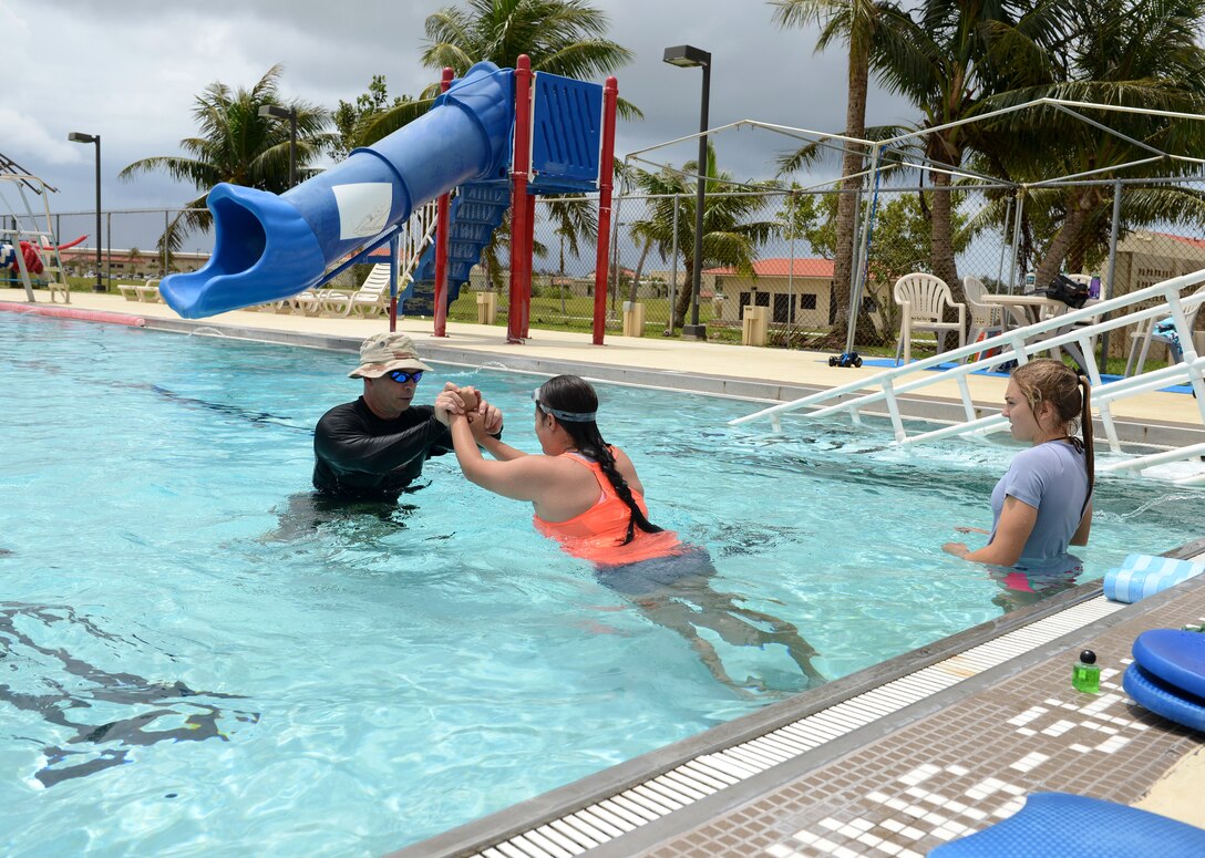 Maj. Michael Curtin, 36th Medical Operations Squadron Health Promotion Flight commander, instructs a group aquatic class July 7, 2015, at Andersen Air Force Base, Guam.  The class is designed for post-operation patients who need a lower impact exercise. (U.S. Air Force photo by Airman 1st Class Arielle Vasquez/Released)
