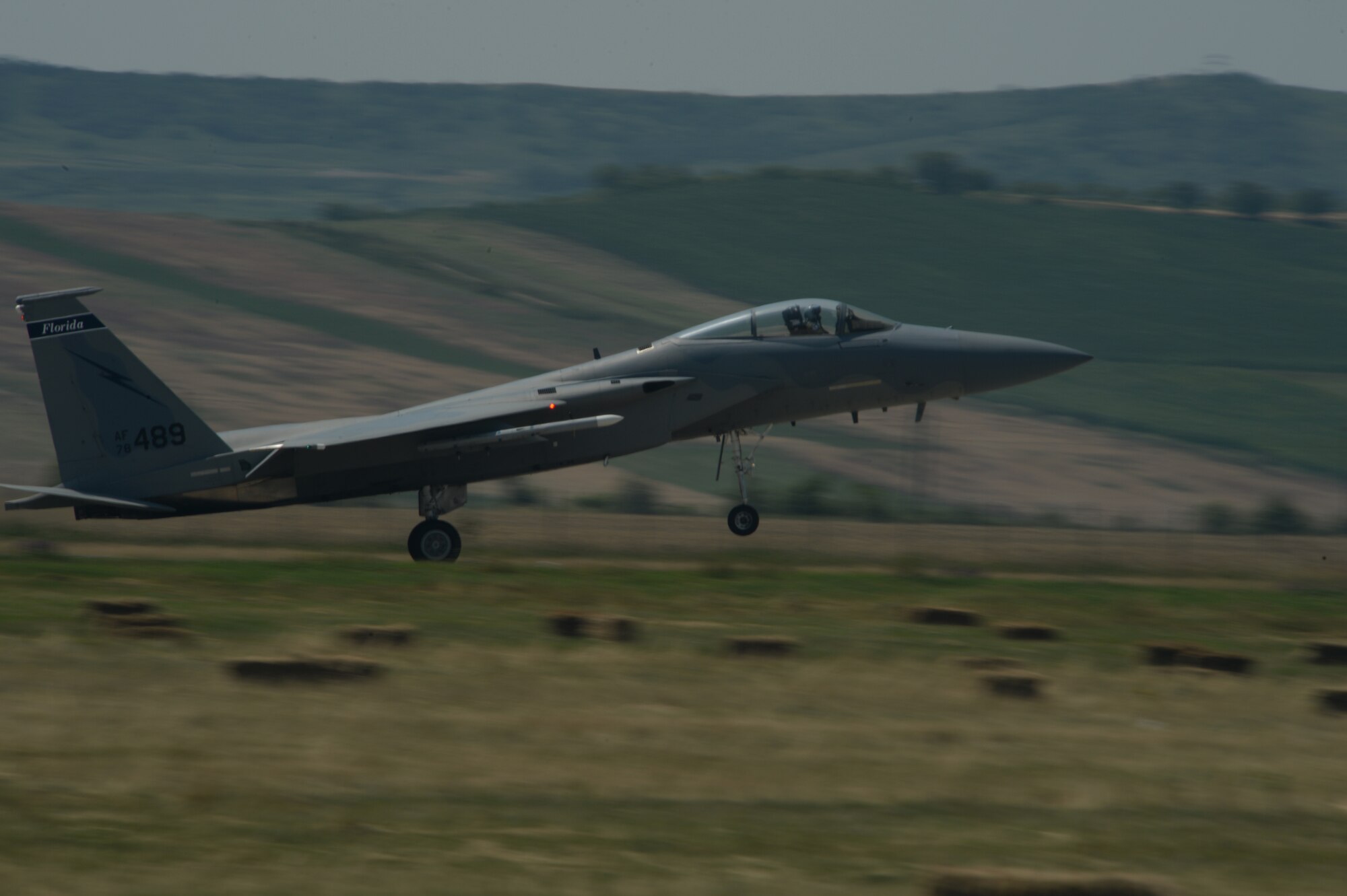 A U.S. Air National Guard F-15C Eagle fighter aircraft pilot assigned to the 123rd Expeditionary Fighter Squadron lands during a theater security package deployment July 7, 2015, at Campia Turzii, Romania. U.S. Air Force fighter squadrons have previously deployed as part of similar theater security packages to the Pacific theater since 2004. (U.S. Air Force photo by Senior Airman Dylan Nuckolls/Released)