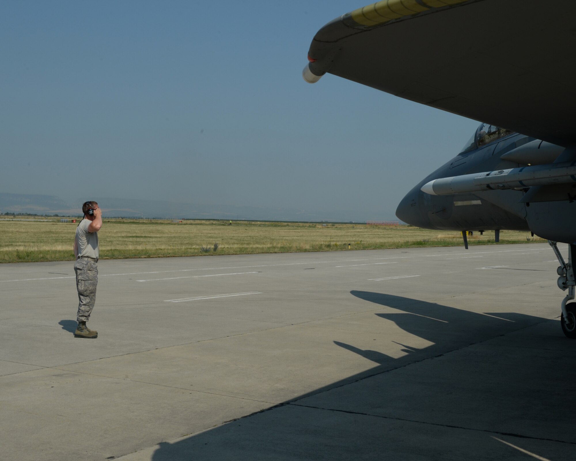 A U.S. Air National Guard crew chief from the 123rd Expeditionary Fighter Squadron salutes the pilot of an U.S. Air Force F-15C Eagle fighter aircraft during a theater security package deployment July 7, 2015, at Campia Turzii, Romania. The aircraft deployed to Romania in support of Operation Atlantic Resolve to bolster air power capabilities while underscoring the U.S. commitment to European security and stability. (U.S. Air Force photo by Senior Airman Dylan Nuckolls/Released)