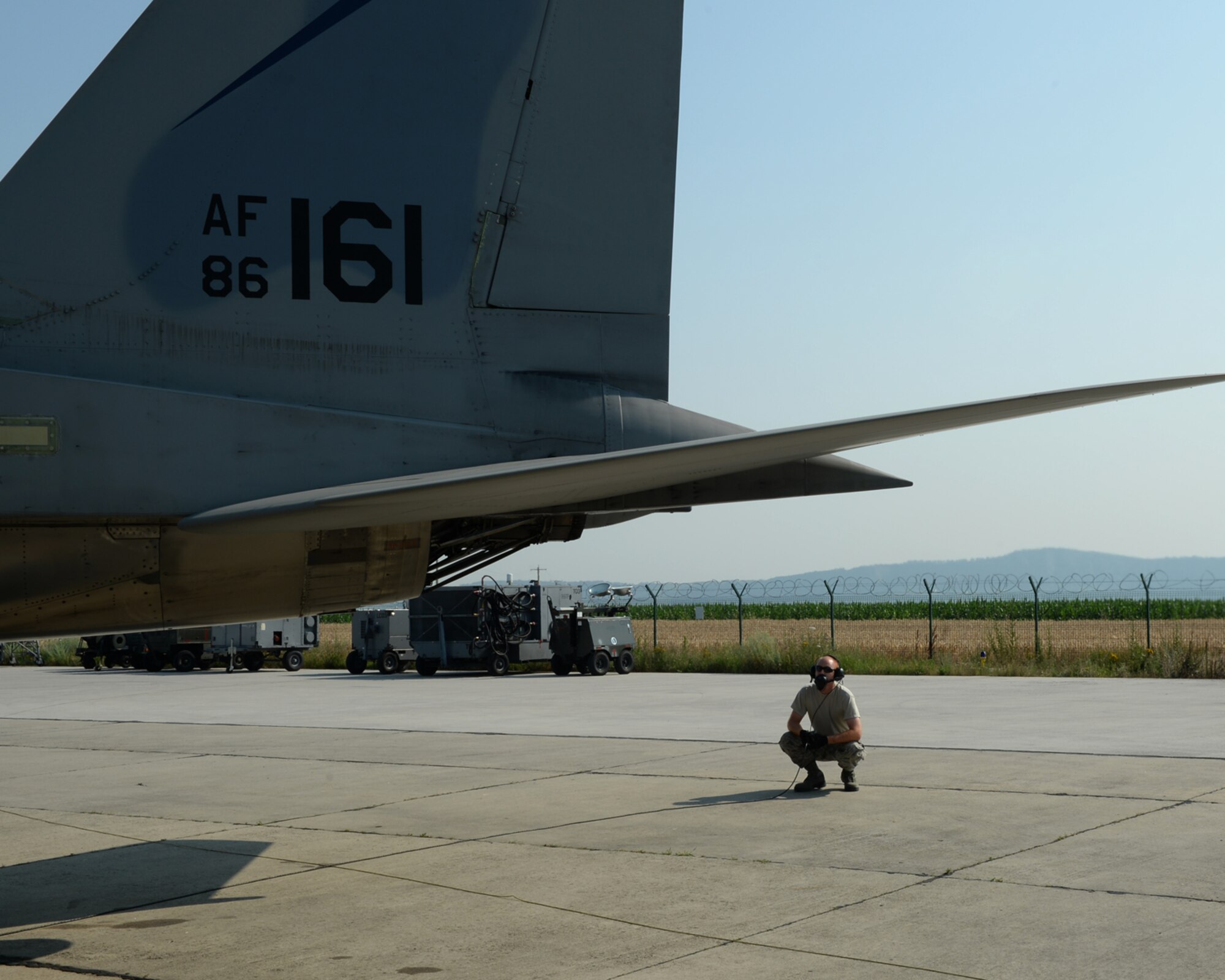 A U.S. Air National Guard crew chief from the 123rd Expeditionary Fighter Squadron performs pre-flight checks on a U.S. ANG F-15C Eagle fighter aircraft during a theater security package deployment July 7, 2015, at Campia Turzii, Romania. The U.S. Air Force’s forward presence in Europe allows cooperation among NATO allies and partners to develop and improve ready air forces capable of maintaining regional security. (U.S. Air Force photo by Senior Airman Dylan Nuckolls/Released)