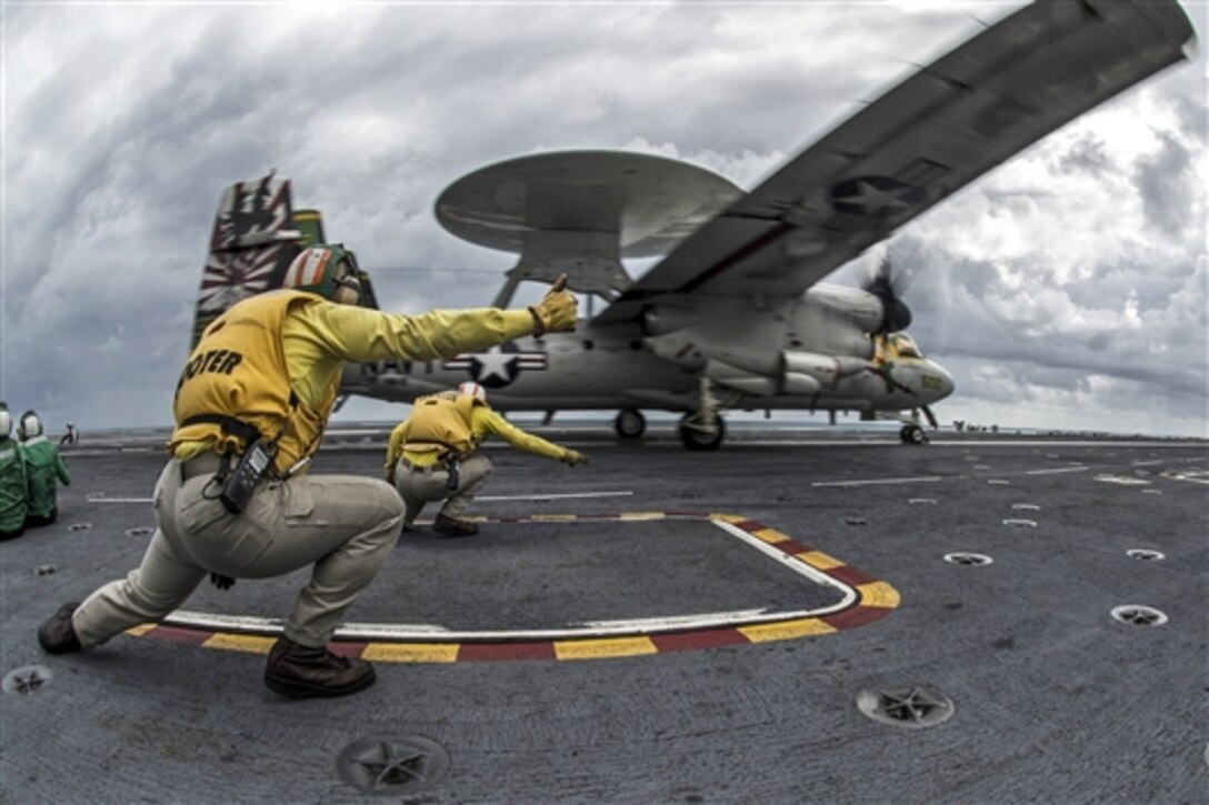 U.S. Navy Lts. Morgan George, foreground, and Kieth Ferrell, launch an E-2C Hawkeye aboard the USS George Washington during Talisman Sabre 2015 in the Timor Sea, July 9, 2015. The biennial exercise involves nearly 30,000 U.S. and Australian service members.