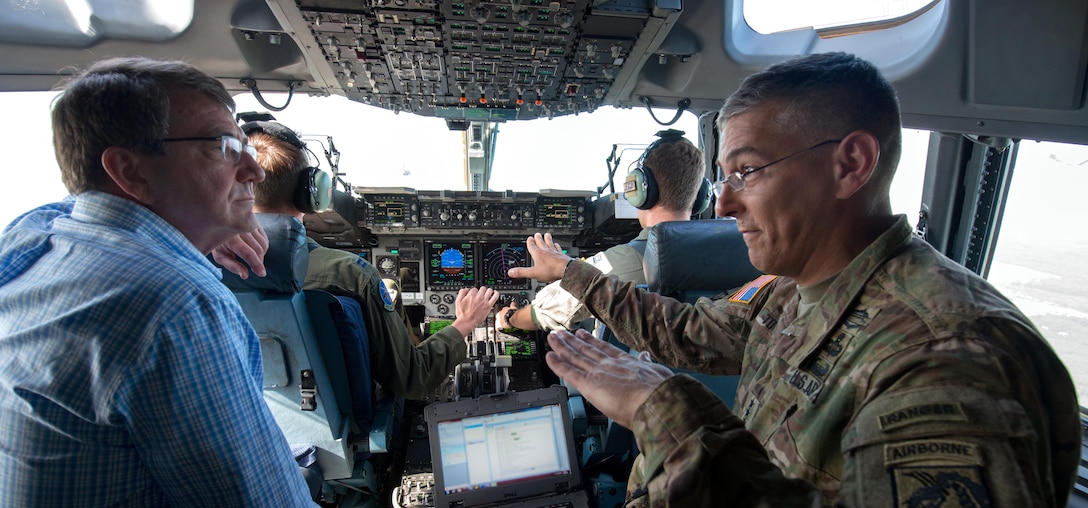 Army Lt. Gen. Stephen J. Townsend, right, commanding general of the XVIII Airborne Corps, talks with Defense Secretary Ash Carter as they fly over the Sicily drop zone during an airborne operation on Fort Bragg, N.C., July 10, 2015.